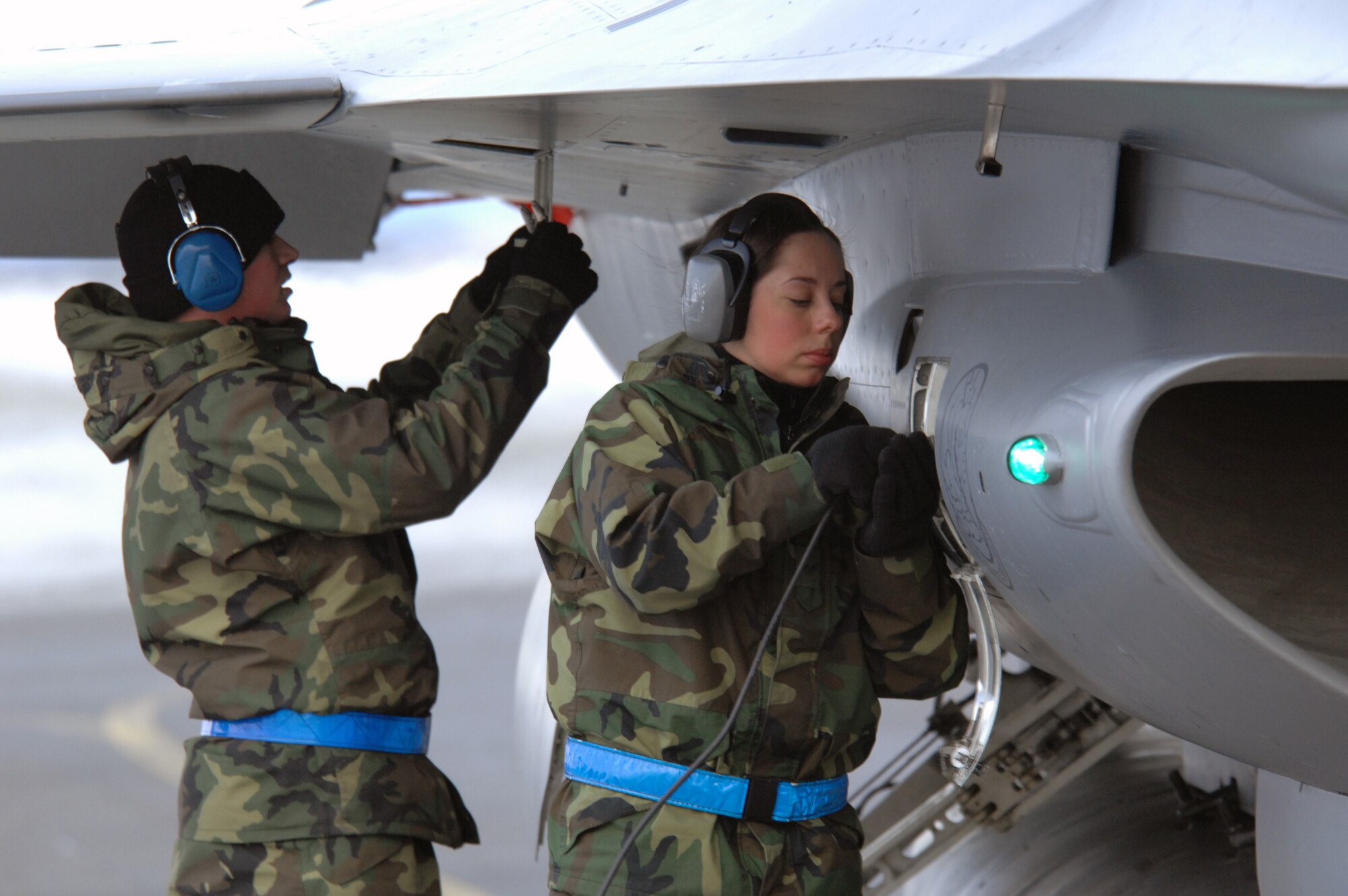 EIELSON AIR FORCE BASE, Alaska -- Senior Airman Amanda Debkowski (right) and Airman First Class Justin Hendrick, 354th Aircraft Maintenance Squadron, prep an F-16C Fighting Falcon as a part of End of Runway crew duties here on Feb. 8. The crew is responsible for arming all weapons and making sure the aircraft is ready for flight. The F-16 is assigned to the 18th Fighter Squadron. The 18th Fighter Squadron conducts air operations for combat-ready F-16 aircraft and provides close air support, forward air control (airborne), battlefield air interdiction, and offensive counter air.
(U.S. Air Force Photo by Staff Sgt Joshua Strang)