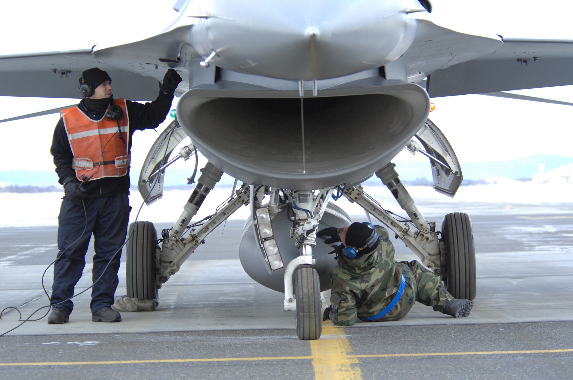 EIELSON AIR FORCE BASE, Alaska -- Staff Sgt Theodore Marx (left) and Airman First Class Justin Hendrick, 354th Aircraft Maintenance Squadron, inspect an F-16C Fighting Falcon as a part of End of Runway crew duties here on Feb. 8. The crew is responsible for arming all weapons and making sure the aircraft is ready for flight. The F-16 is assigned to the 18th Fighter Squadron. The 18th Fighter Squadron conducts air operations for combat-ready F-16 aircraft and provides close air support, forward air control (airborne), battlefield air interdiction, and offensive counter air.
(U.S. Air Force Photo by Staff Sgt Joshua Strang)