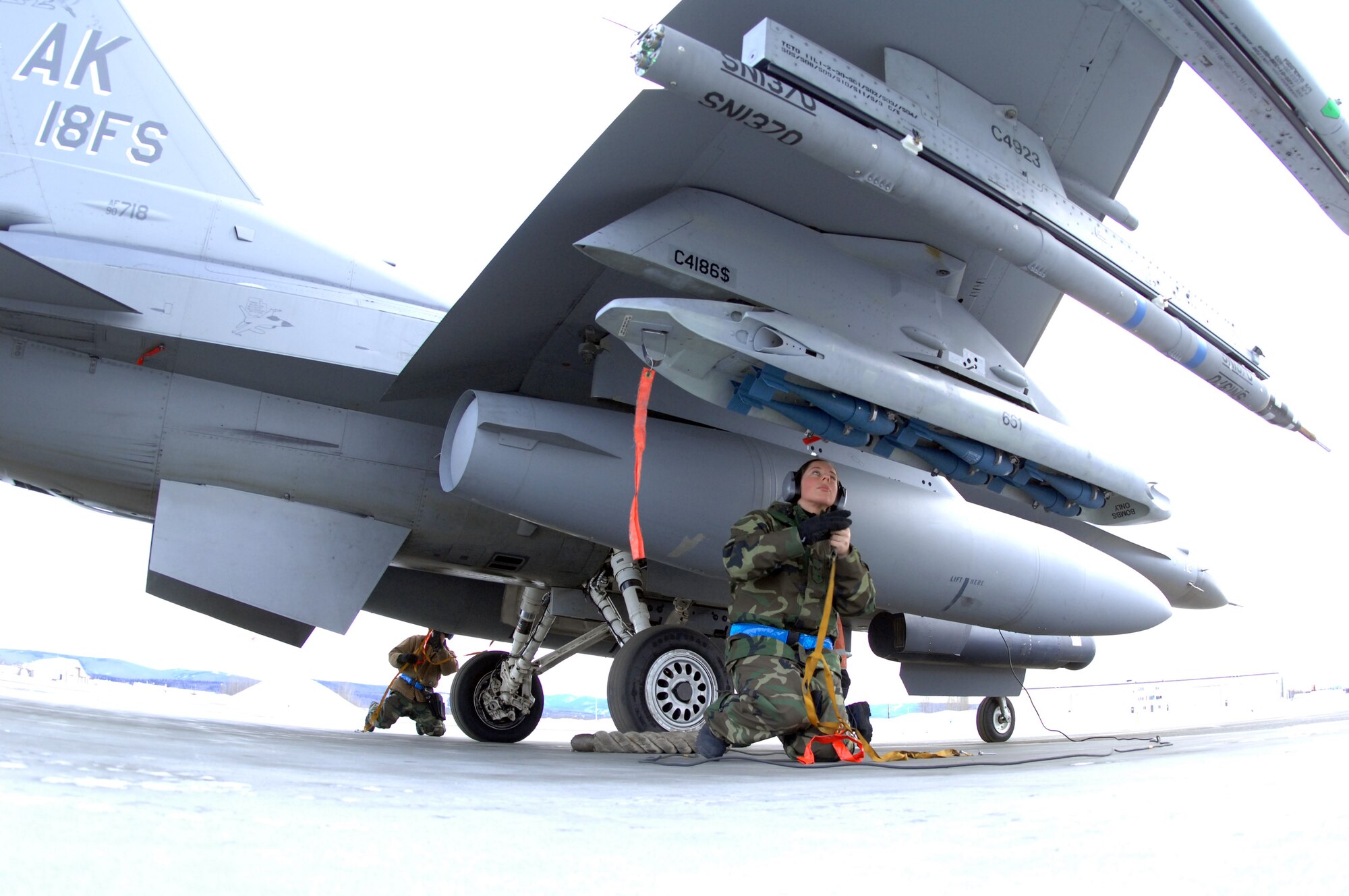 EIELSON AIR FORCE BASE, Alaska -- Senior Airman Amanda Debkowski (front) and Senior Airman Joshua McCathern, 354th Aircraft Maintenance Squadron, prep an F-16C Fighting Falcon as a part of End of Runway crew duties here on Feb. 8. The crew is responsible for arming all weapons and making sure the aircraft is ready for flight. The F-16 is assigned to the 18th Fighter Squadron. The 18th Fighter Squadron conducts air operations for combat-ready F-16 aircraft and provides close air support, forward air control (airborne), battlefield air interdiction, and offensive counter air.
(U.S. Air Force Photo by Staff Sgt Joshua Strang)