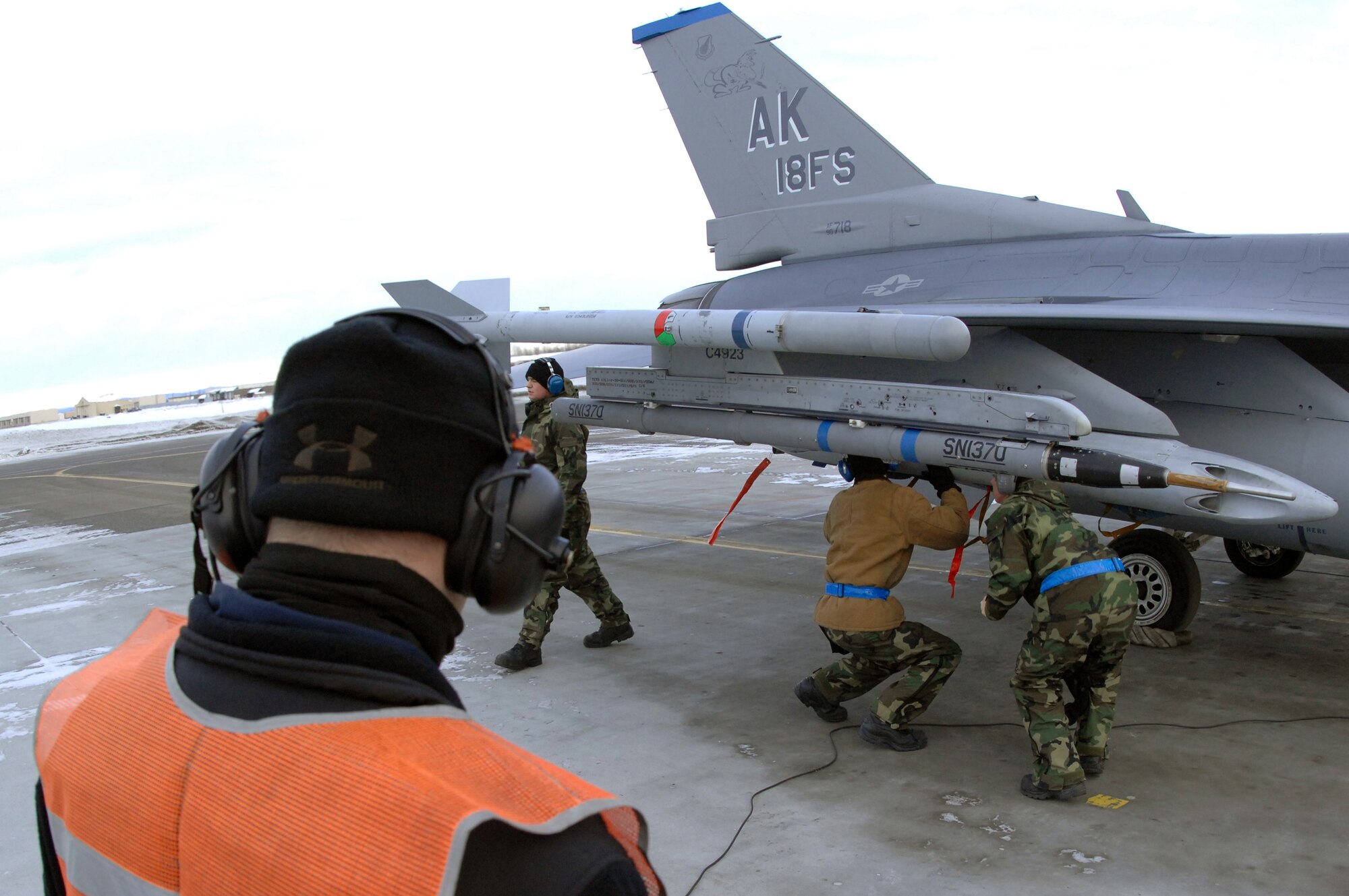EIELSON AIR FORCE BASE, Alaska -- Staff Sgt Theodore Marx (near), Crew Chief, 354th Aircraft Maintenance Squadron, looks on as an F-16C Fighting Falcon is armed during End of Runway duties here on Feb. 8. The crew is responsible for arming all weapons and making sure the aircraft is ready for flight. The F-16 is assigned to the 18th Fighter Squadron. The 18th Fighter Squadron conducts air operations for combat-ready F-16 aircraft and provides close air support, forward air control (airborne), battlefield air interdiction, and offensive counter air.
(U.S. Air Force Photo by Staff Sgt Joshua Strang)