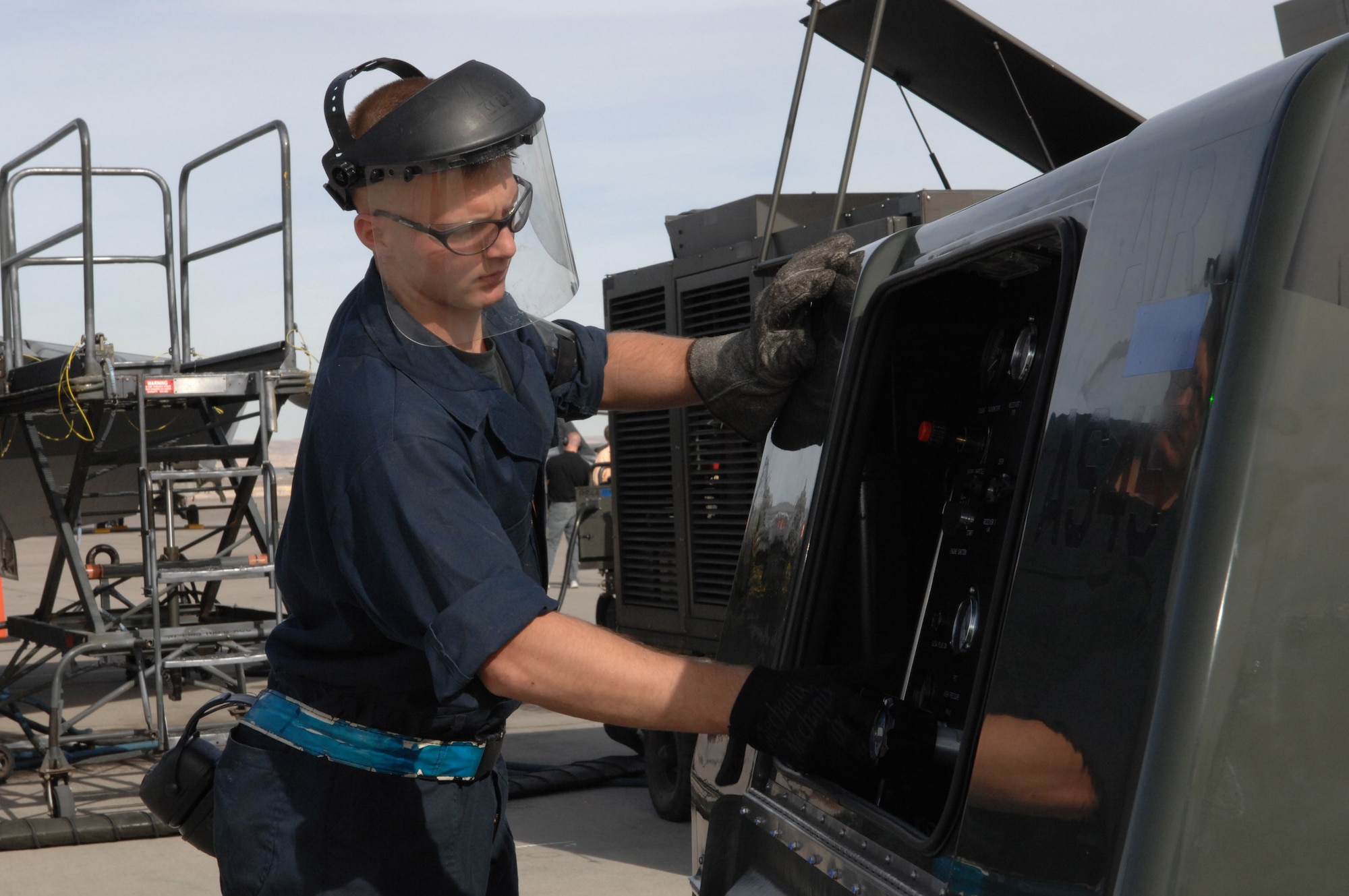 Senior Airman Seth Klepper services a stored energy system during Red Flag 07-02 Feb. 6 at Nellis Air Force Base, Nev. Red Flag sharpens aircrews' warfighting skills in realistic combat situations. The F-22s will be flying missions during the day and night to the nearby Nevada Test and Training Range where they will simulate an air war. The Air Force and Navy, along with military forces from Australia and the United Kingdom, are participating in Red Flag. Airman Klepper is a tactical aircraft maintenance specialist with the 94th Fighter Squadron at Langley Air Force Base, Va. This is the first deployment to Red Flag for the 94th FS with the F-22. (U.S. Air Force photo/Airman 1st Class Nadine Y. Barclay)

