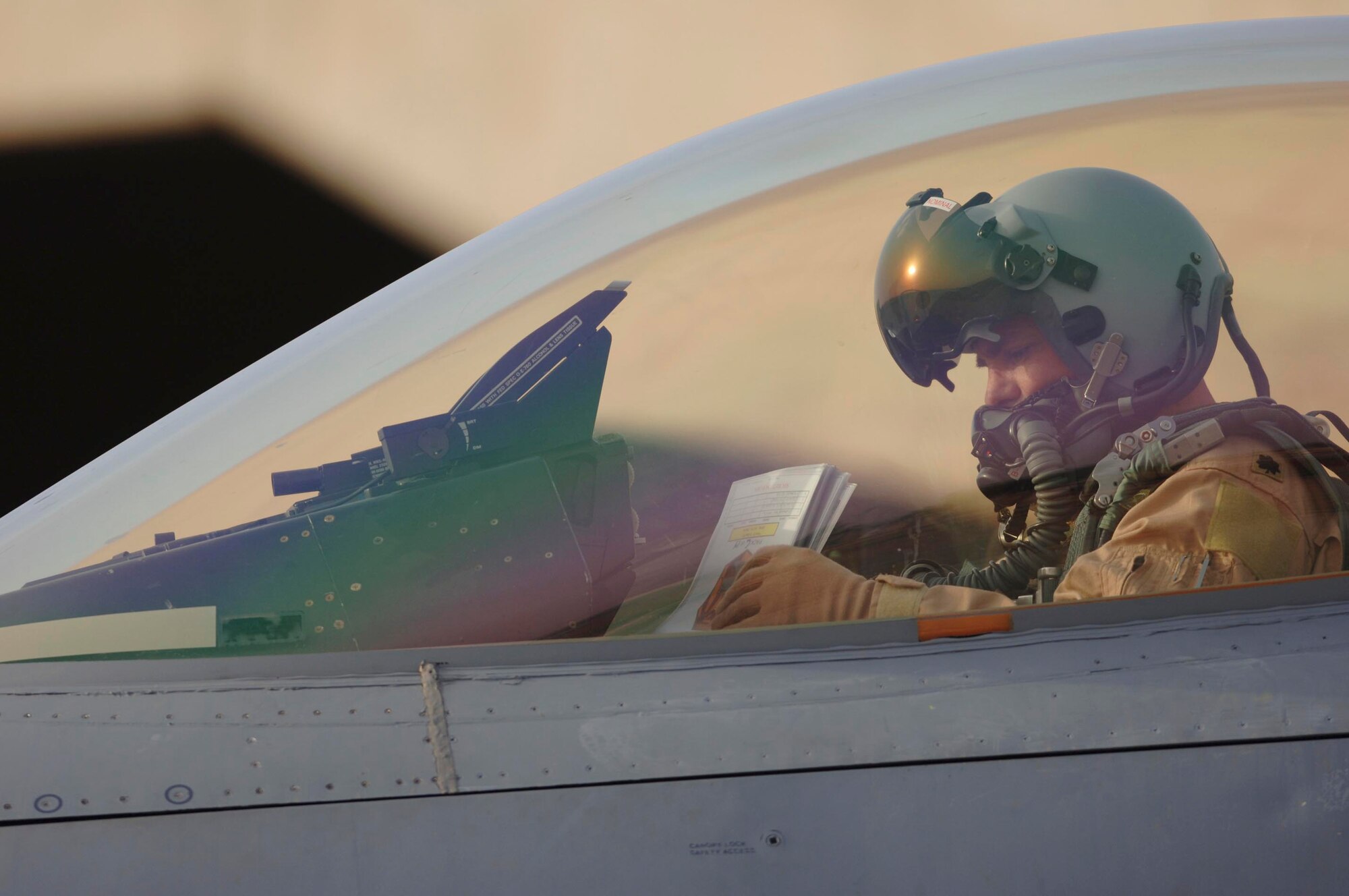 BALAD AIR BASE, Iraq -- Lt Col. Chris "Crash" Ashby, 332nd Air Expeditionary Wing chief of safety, sits in an F-16 and goes over his checklist one more time before departing Jan. 29 on a combat mission over Iraq. Colonel Ashby is the 20th Fighter Wing chief of safety at Shaw Air Force Base, S.C. He is currently serving a 120-day deployment in Iraq. (U. S. Air Force photo/Staff Sgt. Michael R. Holzworth)

