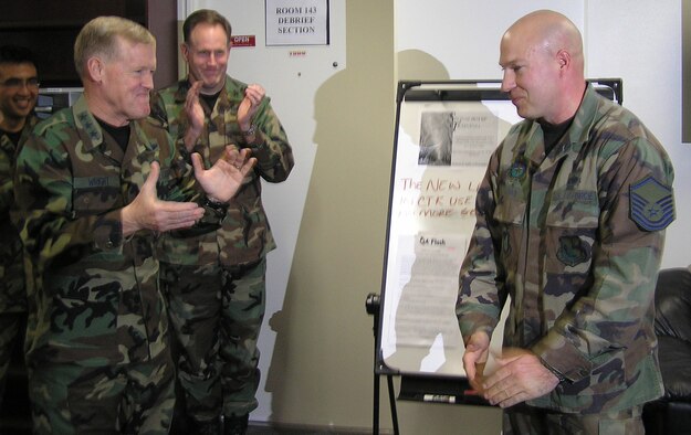 Master Sgt. Jeff Harris, 374th Aircraft Maintenance Squadron, is congratulated by Lt. Gen. Bruce Wright, United States Forces Japan and 5th Air Force commander, and Col. Scott Goodwin, 374th Airlift Wing commander during a surprise promotion ceremony, as part of the 5 AF Stripes for Exceptional Performers program , at the 374 AMXS nightshift roll call Jan. 24. Master Sgt. Leopoldo Polance-Sierra, 374th Operations Support Squadron, Tech. Sgt. Donald Cruz, 459th Airlift Squadron and Tech. Sgt. Robert Lumaban, 374th Mission Support Squadron were also recently STEP promoted in December. (U.S. Air Force photo by Maj. David Westover)  