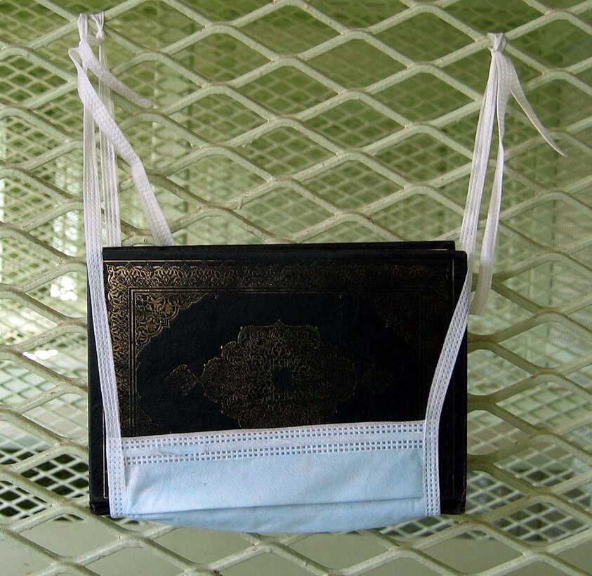 A Koran hangs in a surgical mask in Camp 1. The Muslim holy  book is hung up on the wall to give it a place of reverence. Photo by Kathleen  T. Rhem