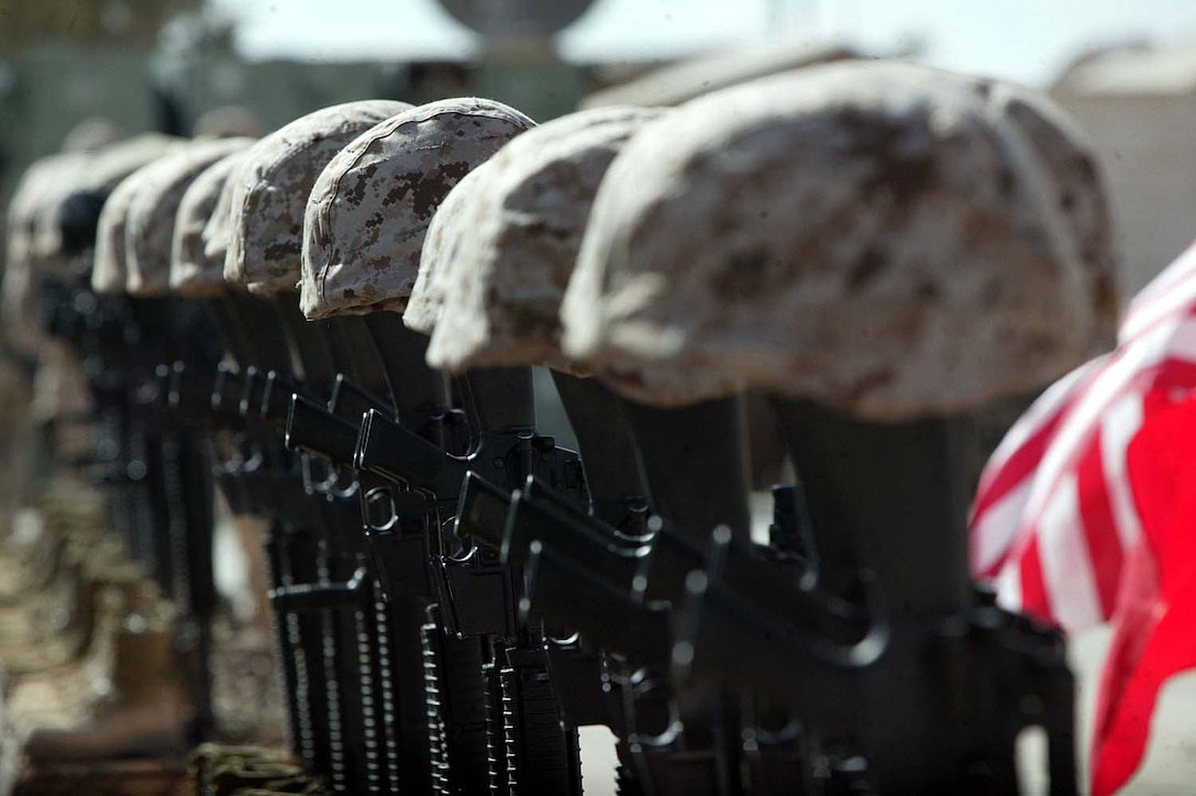 Helmets, service rifles and boots represent the 30 U.S. 
Marines and one sailor of Company C, Battalion Landing Team 1st Battalion, 3rd 
Marine Regiment, 31st Marine Expeditionary Unit, and Marine Heavy Helicopter 
Squadron-361, 3rd Marine Aircraft Wing, who died in a CH53-E Super Stallion 
helicopter crash Jan. 26, and three of the ground unit's Marines, who died 
during the fight for Fallujah, during a memorial service in western Iraq Feb. 
2.