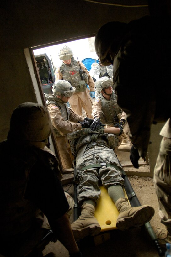 Balad Air Base, Iraq -- Airmen and Soldiers prepare a wounded soldier for a medical evacuation during a perimeter tower rescue exercise, Feb. 9.  The soldier simulated being wounded in a watch tower.  This joint exercise evaluates the emergency response time and skills of the 332nd Expeditionary Civil Engineer Squadron fire department, the 60th Ordinance Company, and 206th Army Support Medical Company. Sgt Christopher Babich is with the 206th Army Support Medical Company.  (US Air Force photo/Tech. Sgt. Cecilio Ricardo)(released)