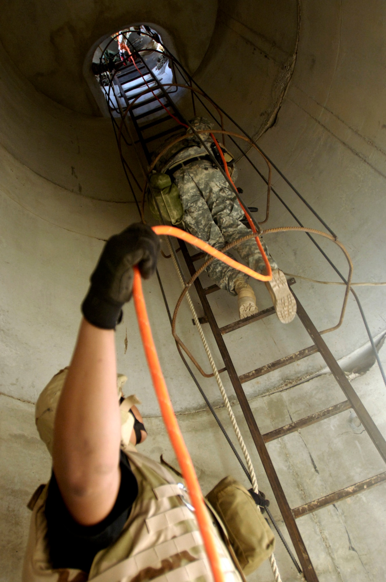 Balad Air Base, Iraq --  Sgt. Christopher Babich climbs the tower to assess the situation on how to extract a wounded soldier during a perimeter tower rescue exercise, Feb. 9.  This joint exercise evaluates the emergency response time and skills of the 332nd Expeditionary Civil Engineer Squadron fire department, the 60th Ordinance Company, and 206th Army Support Medical Company. Sgt Christopher Babich is with the 206th Army Support Medical Company.  (US Air Force photo/Tech. Sgt. Cecilio Ricardo)(released)