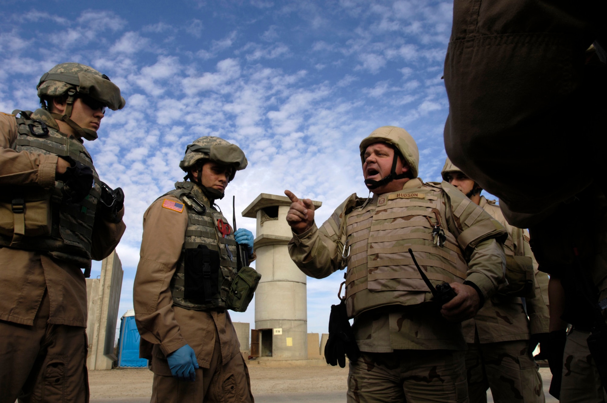 Balad, Iraq -- Master Sgt. Wesley Hudson briefs his firefighter team on how to proceed during this perimeter tower rescue exercise, Feb. 9.   This joint exercise evaluates the emergency response time and skills of the 332nd Expeditionary Civil Engineer Squadron fire department, the 60th Ordinance Company, and 206th Army Support Medical Company.  (US Air Force photo/Tech. Sgt. Cecilio Ricardo)(released)