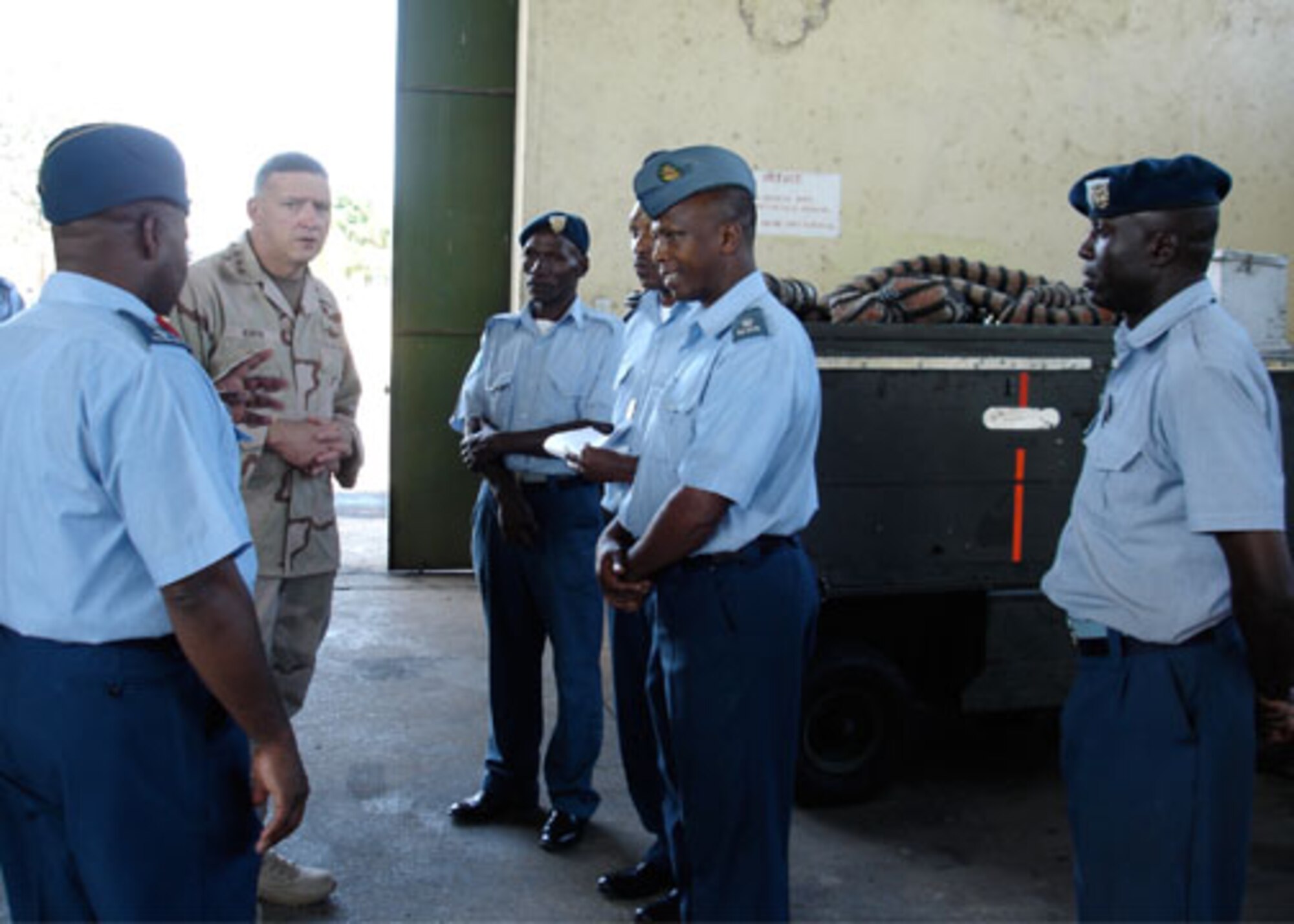 Kenya Air Force Maj. Githaiga (center) engages members of the aircraft ground equipment maintenance unit in discussion with Lt. Gen. Gary North, U.S. Central Command Air Forces commander, at Laikipia Air Base, during the general's visit to Nairobi Feb. 8.  General North met with Kenya Air Force officials to continue a dialogue of cooperation and mutual operational goals. (U.S. Air Force photo)