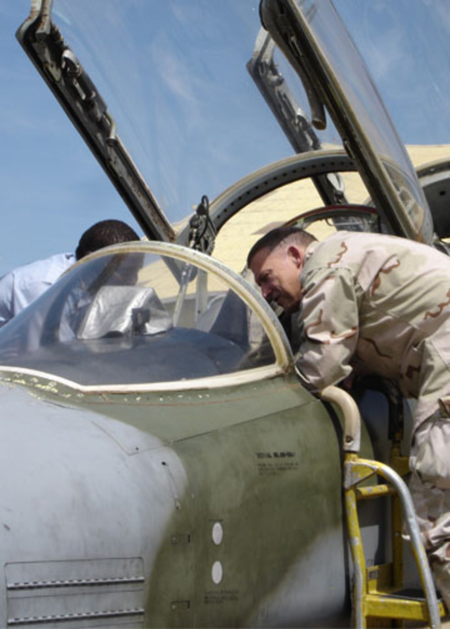 Kenya Air Force Maj. Mbogua, an F-5 pilot, discusses aircraft avionics and weapons systems with Lt. Gen. Gary North, U.S. Central Command Air Forces commander, at Laikipia Air Base, Nairobi, Kenya, Feb. 8, as both peer into the cockpit of one of the service's F-5s.  While in Kenya, General North also met with Brig. Gen. Jackson Waheru, deputy commander of the Kenya Air Force, to discuss current and future security cooperation efforts. (U.S. Air Force photo)