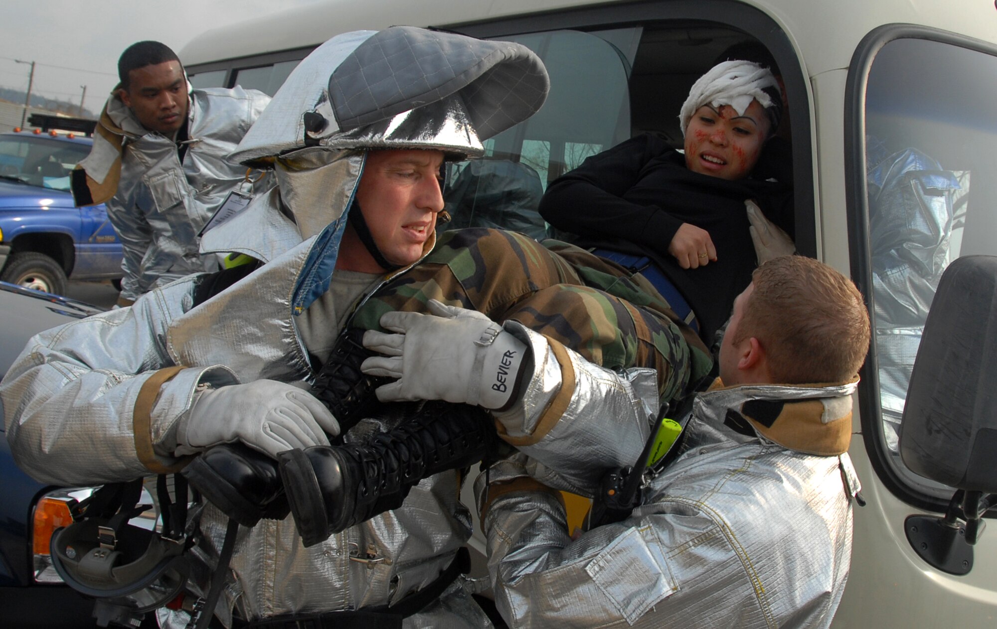Members of the 8th Fighter Wing disaster response team rescue Staff Sgt. Kim Juliano from a vehicle during a simulated traffic accident Feb. 9. The major accident response exercise on Kunsan Air Base, South Korea, was designed to provide realistic training for emergency response teams and simulated a major vehicle accident with multiple victims.  Sergeant Juliano is assigned to the 8th Communications Squadron.  (U.S. Air Force photo/Tech Sgt. Jeffrey A. Wolfe)