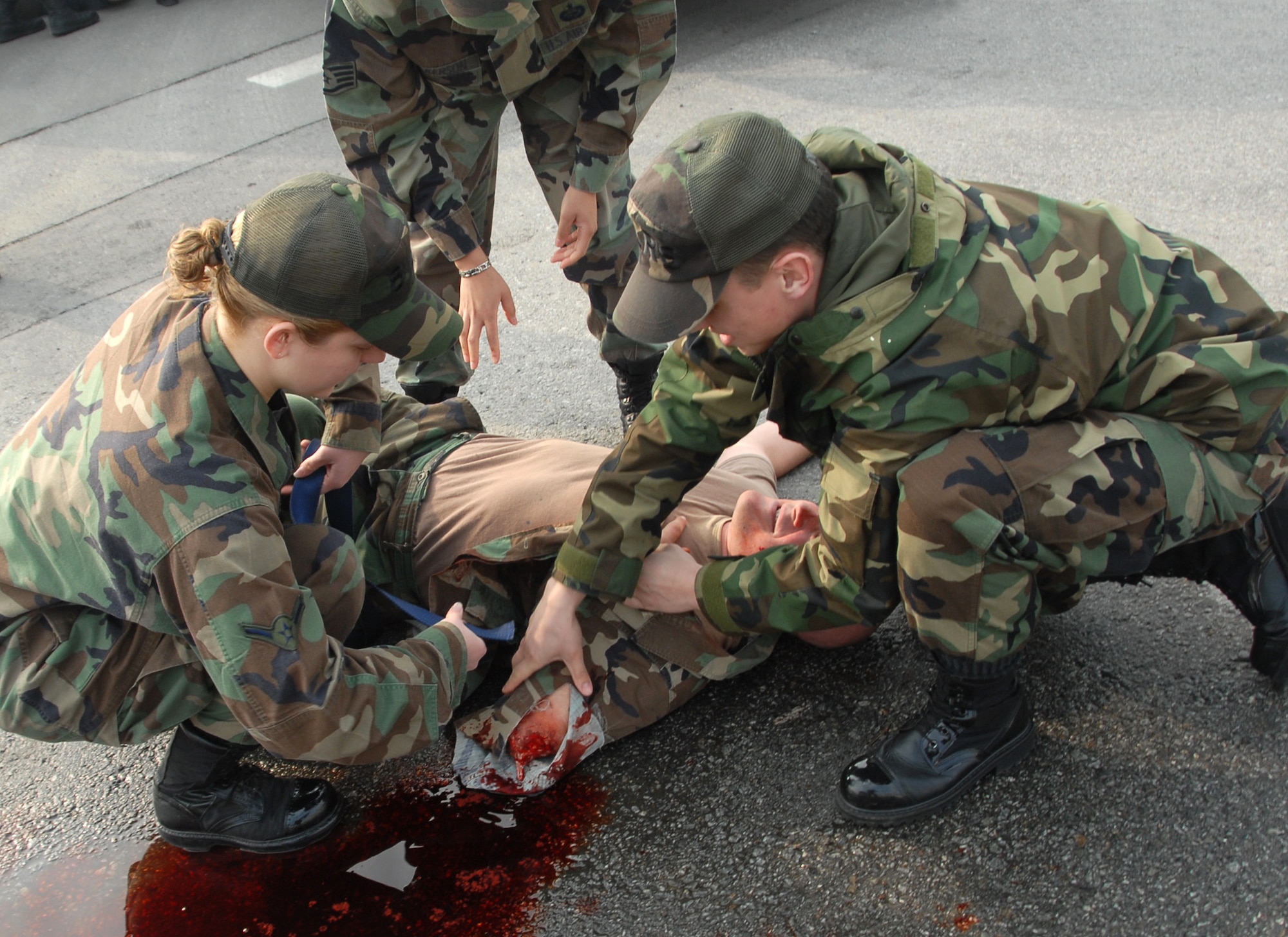 Members of the 8th Fighter Wing disaster response team perform first aid on a simulated accident victim Feb. 9 during a major accident response exercise on Kunsan Air Base, South Korea. The accident, designed to provide realistic training for emergency response teams, simulated a major vehicle accident with multiple victims. (U.S. Air Force photo/Tech Sgt. Jeffrey A. Wolfe)

