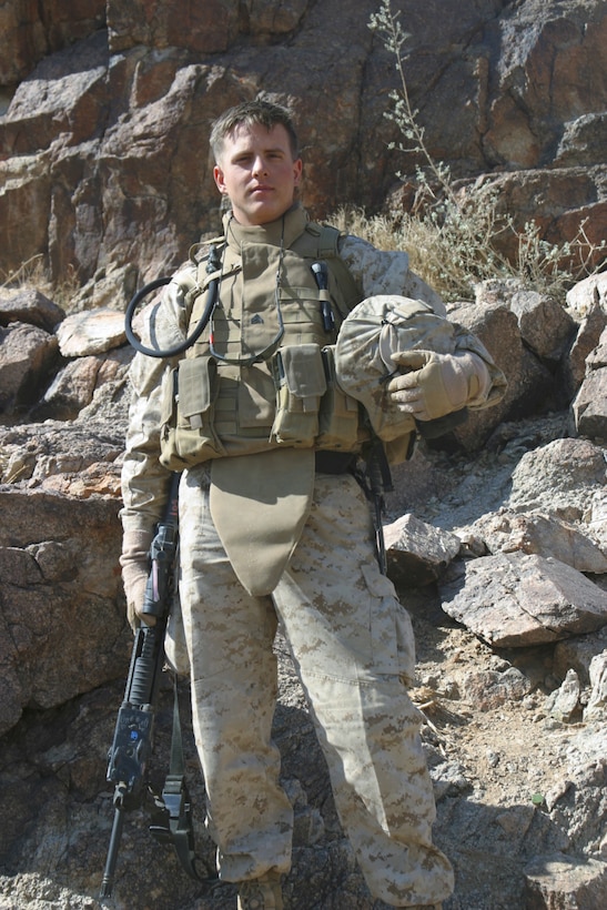 Corporal Anthony P. Mitchell, intelligence analyst, Alpha Company, 1st Battalion, 3rd Marine Regiment, pauses for a photograph at range 400 at Twenty-nine Palms, Calif., Feb. 11. Mitchell, who joined the Marine Corps June 6, 2004, said he is unsure whether or not he will continue his career in the Corps but said whether he does or not, he wants to stay in the intelligence field.