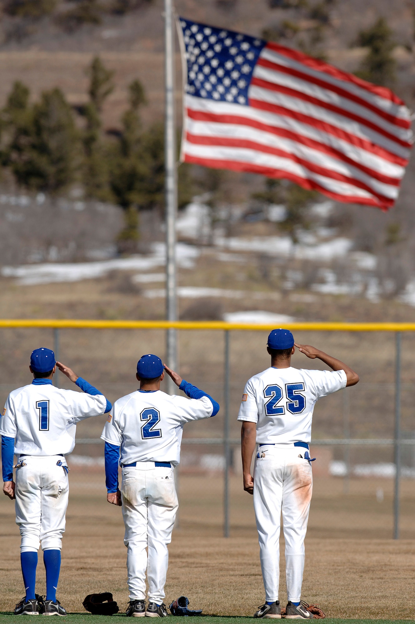 Air Force Academy Men Falcons baseball team members freshman K.J. Randhawa, senior Geno Salazar and freshman Spencer Tate render a salute before the start of a three-game series against the Northern Colorado Bears Feb 10. (U.S. Air Force photo/Mike Kaplan)