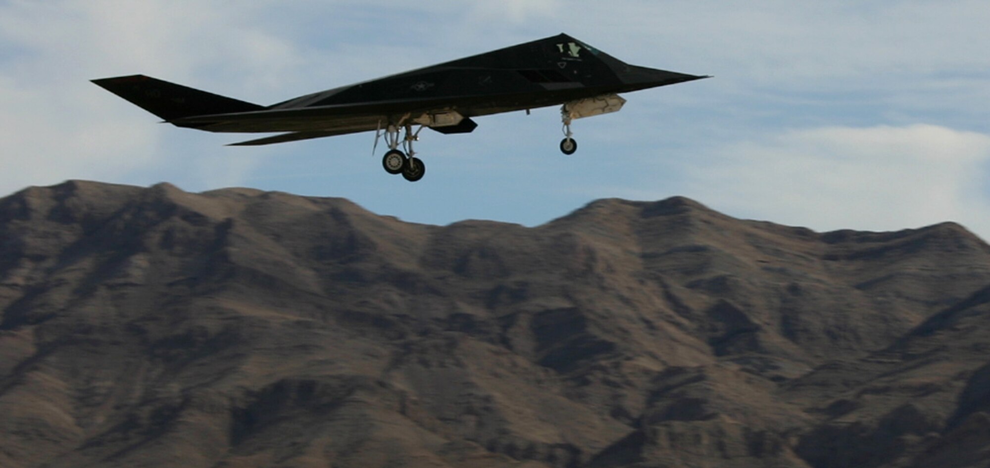 An F-117 Nighthawk stealth fighter lands at Nellis Air Force Base, Nev., after a Red Flag mission Feb. 12, 2007. All three of the Air Force's stealth aircraft models -- the B-2, F-117 and F-22 -- are taking part in Red Flag, which sharpens aircrews’ war-fighting skills in realistic combat situations. Crews are flying missions during the day and night to the nearby Nevada Test and Training Range where they take part in highly realistic aerial combat. The U.S. Air Force and Navy, along with Australia and the United Kingdom, are participating in February's Red Flag.  (U.S. Air Force photo/Mike Estrada)
