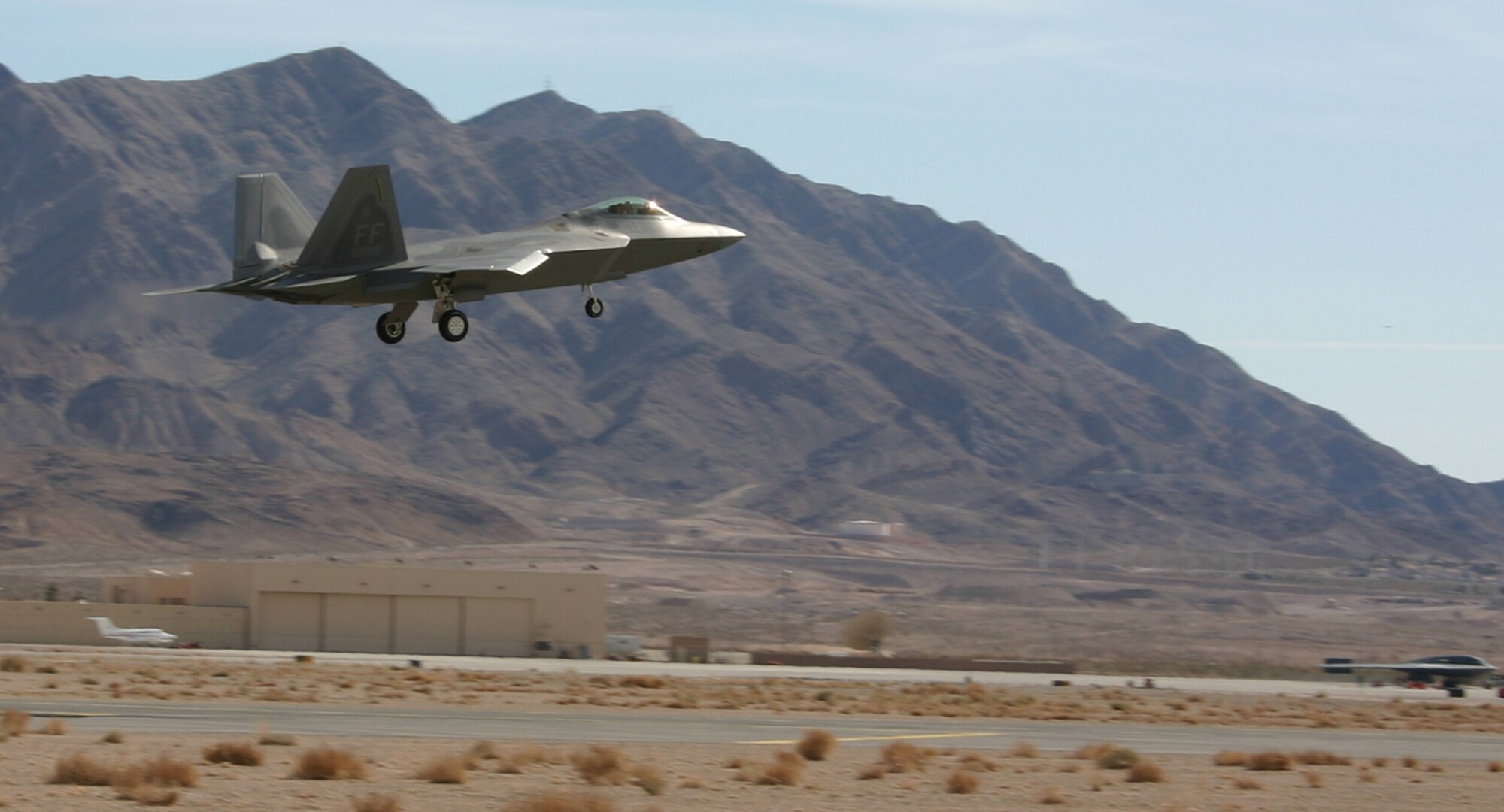An F-22 Raptor from the 1st Fighter Wing, Langley Air Force Base, Va., lands at Nellis after a Red Flag mission Feb. 12, 2007. The F-22s are making their first appearance in Red Flag, along with veteran stealth aircraft F-117 Nighthawk fighters and B-2 Spirit bombers. Red Flag sharpens aircrews’ war-fighting skills in realistic combat situations. Crews are flying missions during the day and night to the nearby Nevada Test and Training Range where they take part in highly realistic aerial combat. The U.S. Air Force and Navy, along with Australia and the United Kingdom, are participating in February's Red Flag.  (U.S. Air Force photo/Mike Estrada)