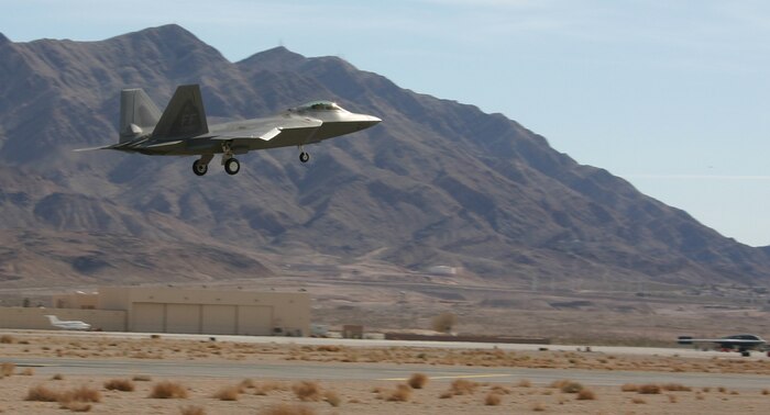 An F-22 Raptor from the 1st Fighter Wing, Langley Air Force Base, Va., lands at Nellis after a Red Flag mission Feb. 12, 2007. The F-22s are making their first appearance in Red Flag, along with veteran stealth aircraft F-117 Nighthawk fighters and B-2 Spirit bombers. Red Flag sharpens aircrews’ war-fighting skills in realistic combat situations. Crews are flying missions during the day and night to the nearby Nevada Test and Training Range where they take part in highly realistic aerial combat. The U.S. Air Force and Navy, along with Australia and the United Kingdom, are participating in February's Red Flag.  (U.S. Air Force photo/Mike Estrada)