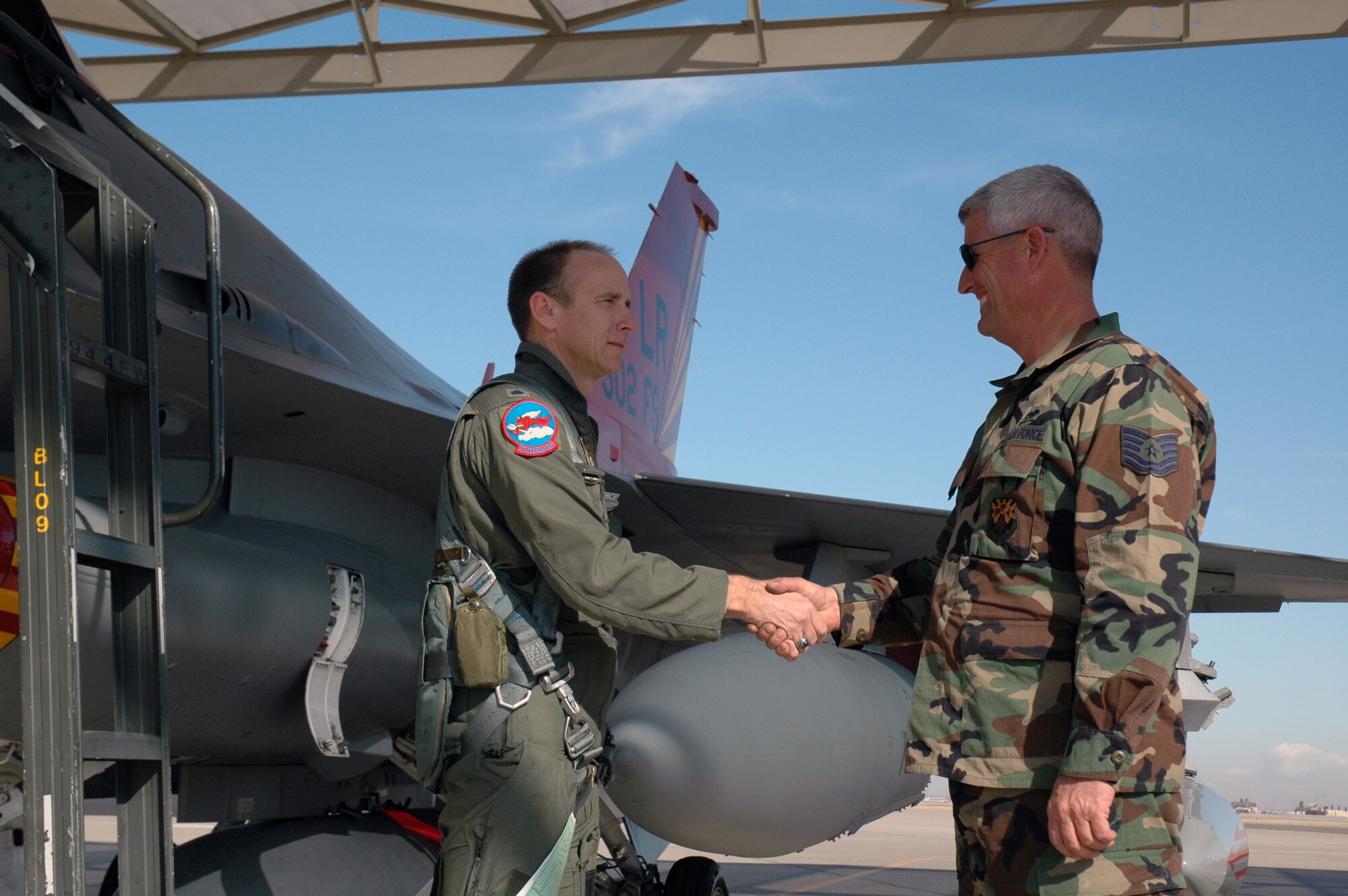 Lt. Col. Donald Lindberg, 302nd Fighter Squadron commander, shakes the hand of his crew chief, Tech. Sgt. Dan Dennison, before taking his final flight in a 944th Fighter Wing F-16. The last three of 17 F-16s assigned to the 944th Fighter Wing departed Feb. 12, 2007, to be reassigned as part of Base Realignment and Closure actions. Two of the final F-16s will go to Nellis Air Force Base, Nev., and will become part of the aggressor squadron. The third will go to an Air National Guard unit in Tucson, Ariz. (U.S. Air Force photo/Staff Sgt. Susan Stout)
