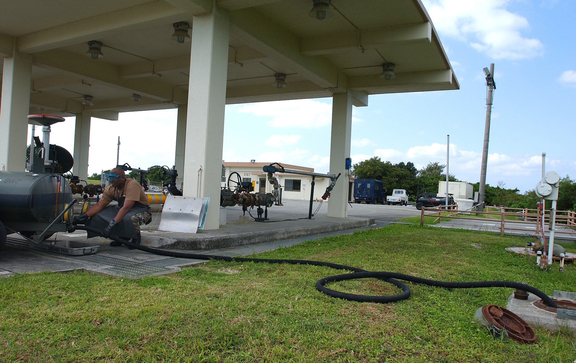 KADENA AIR BASE, Japan -- Airman 1st Class Charles Marcos, 18th Logistics Readiness Squadron, empties a fuel bowser into a fuel collection tank. Fuel bowsers are also used for holding fuel that is emptied from an aircraft so mechanics can work on fuel lines. (U.S. Air Force/Airman 1st Class Kelly Timney)