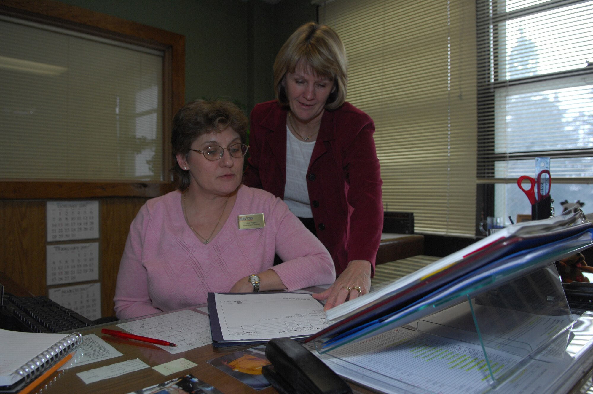 MINOT AIR FORCE BASE, N.D. – Mary Brown (left) and Joni Hogan, both from the 5th Services Squadron, look over paperwork here. Mrs. Brown was recently selected as recently selected 2006 Air Combat Command Services Individual Senior Civilian Manager of the Year.