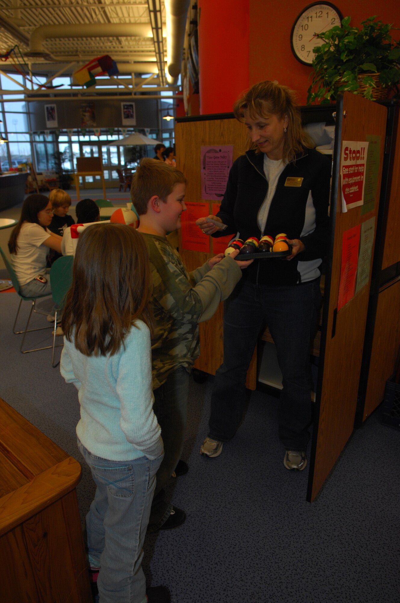 MINOT AIR FORCE BASE, N.D. – Ronda Knutson, 5th Services Squadron, hands out pool balls at the David C. Jones Youth Center here.  Mrs. Knutson was recently selected 2006 Air Combat Command Services Individual Civilian Manager of the Year.