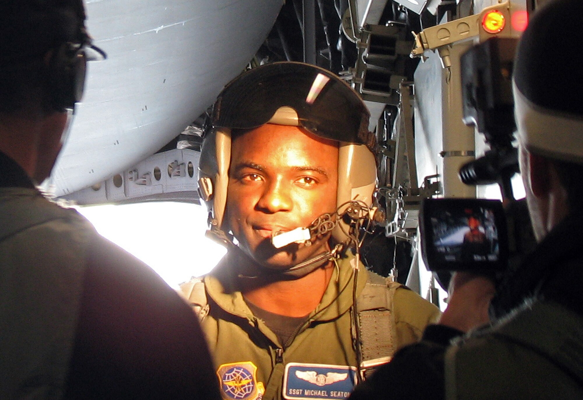 Members of the GSD&M film crew interview Staff Sgt. Michael Seaton, a 17th Airlift Squadron loadmaster, while filming a new Air Force commercial. (U.S. Air Force photo by Capt. Christopher Moore)