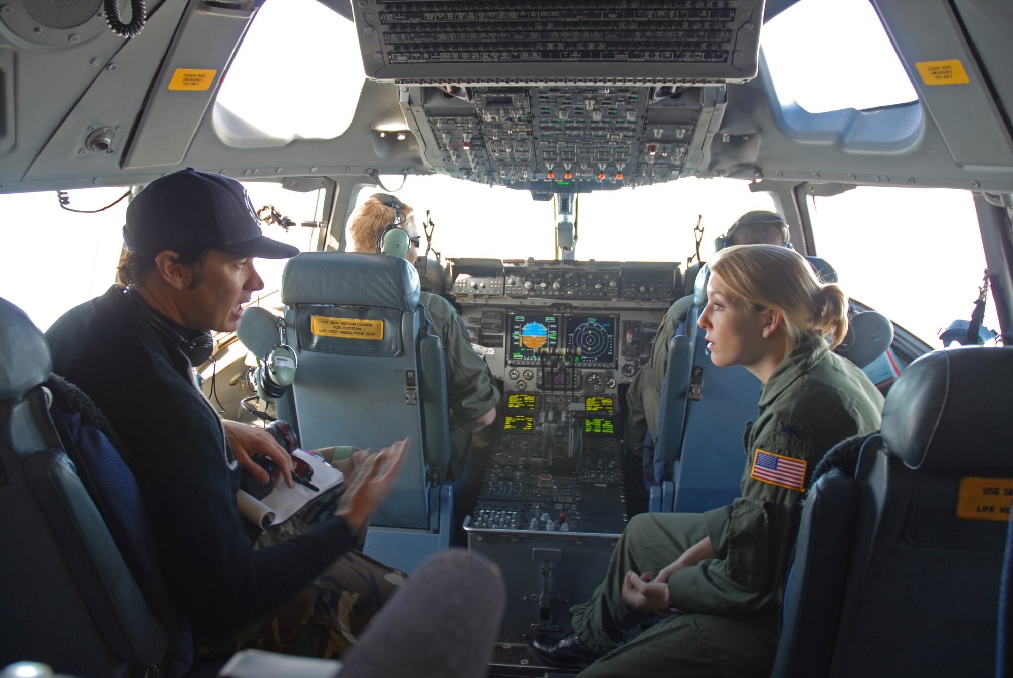 Bill Kiely, GSD&M director, rehearses command messages with 1st Lt. Sueann Lamia, a 17th Airlift Squadron pilot, during filming of an Air Force commercial. (U.S. Air Force photo by Tech. Sgt. Paul Kilgallon)