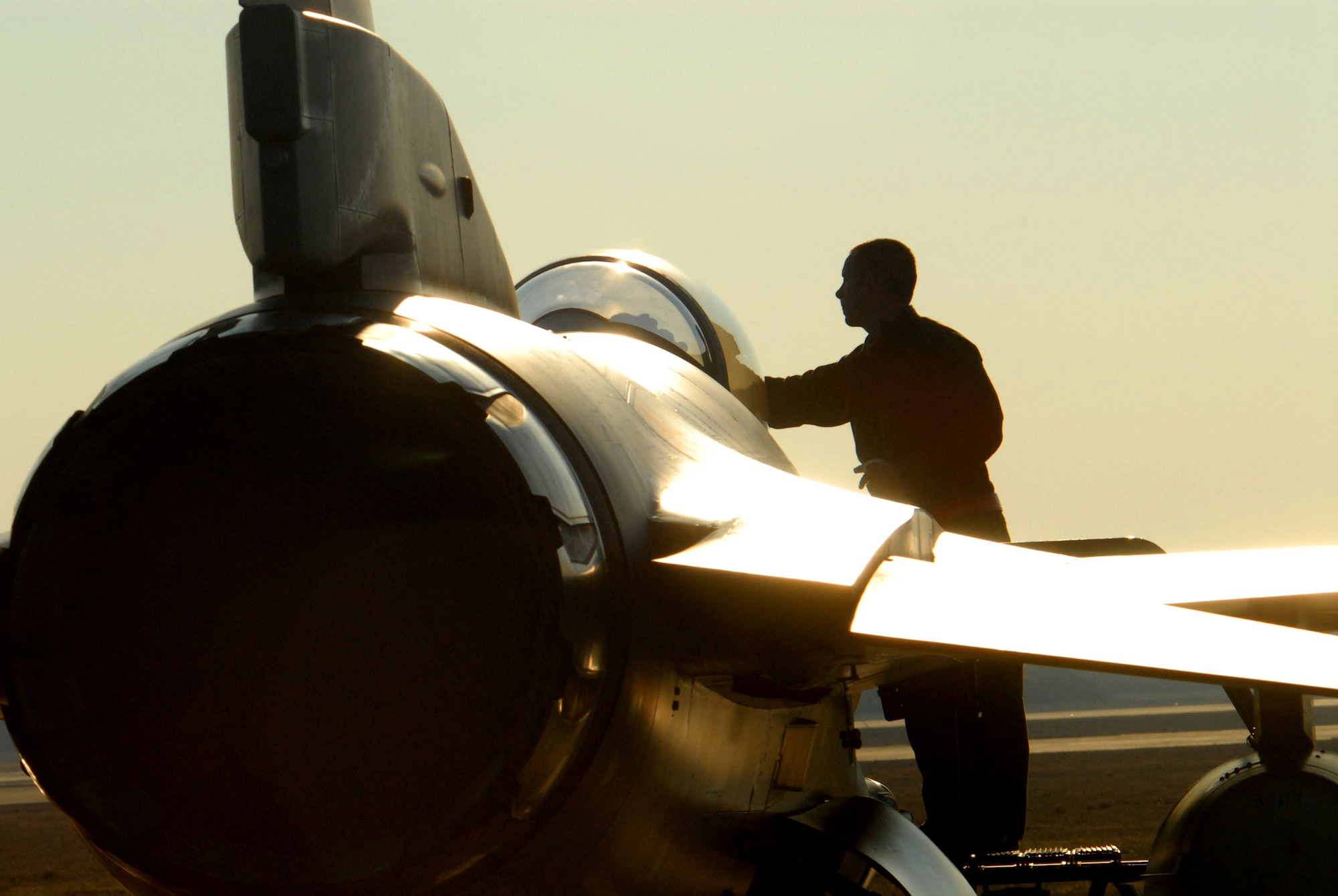 Staff Sgt. Donald Slayton cleans the canopy of an F-16 Fighting Falcon prior to launch during Exercise Iron Thunder Feb. 7, at Shaw Air Force Base, S.C. The objective of the exercise is to prepare units for future contingency operations by offering a chance for players to be exposed to missions identical to those faced in combat. Sergeant Slayton is a 77th Fighter Squadron crew chief. (U.S. Air Force photo/Tech. Sgt. James W. Arrowood)