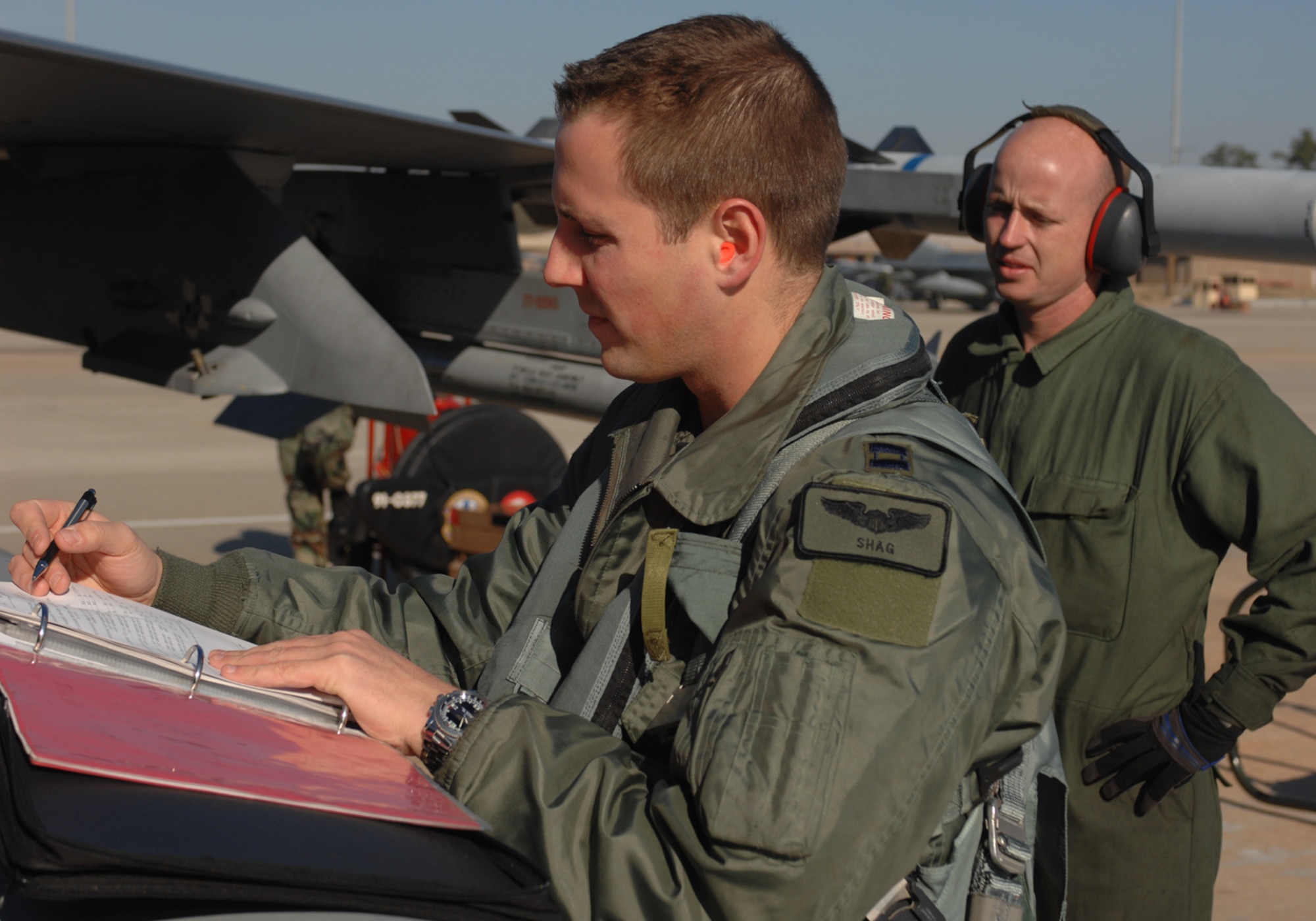 Capt. Todd Adams and Staff Sgt. Donald Dunn prepare an F-16 Fighting Falcon for flight in support of Exercise Iron Thunder Feb. 7 at Shaw Air Force Base, S.C. The excercise helped prepare Airmen for airborne operations while deployed. The two are assigned to the 77th Fighter Squadron at Shaw AFB. (U.S. Air Force photo/Airman 1st Class Matthew Davis)
