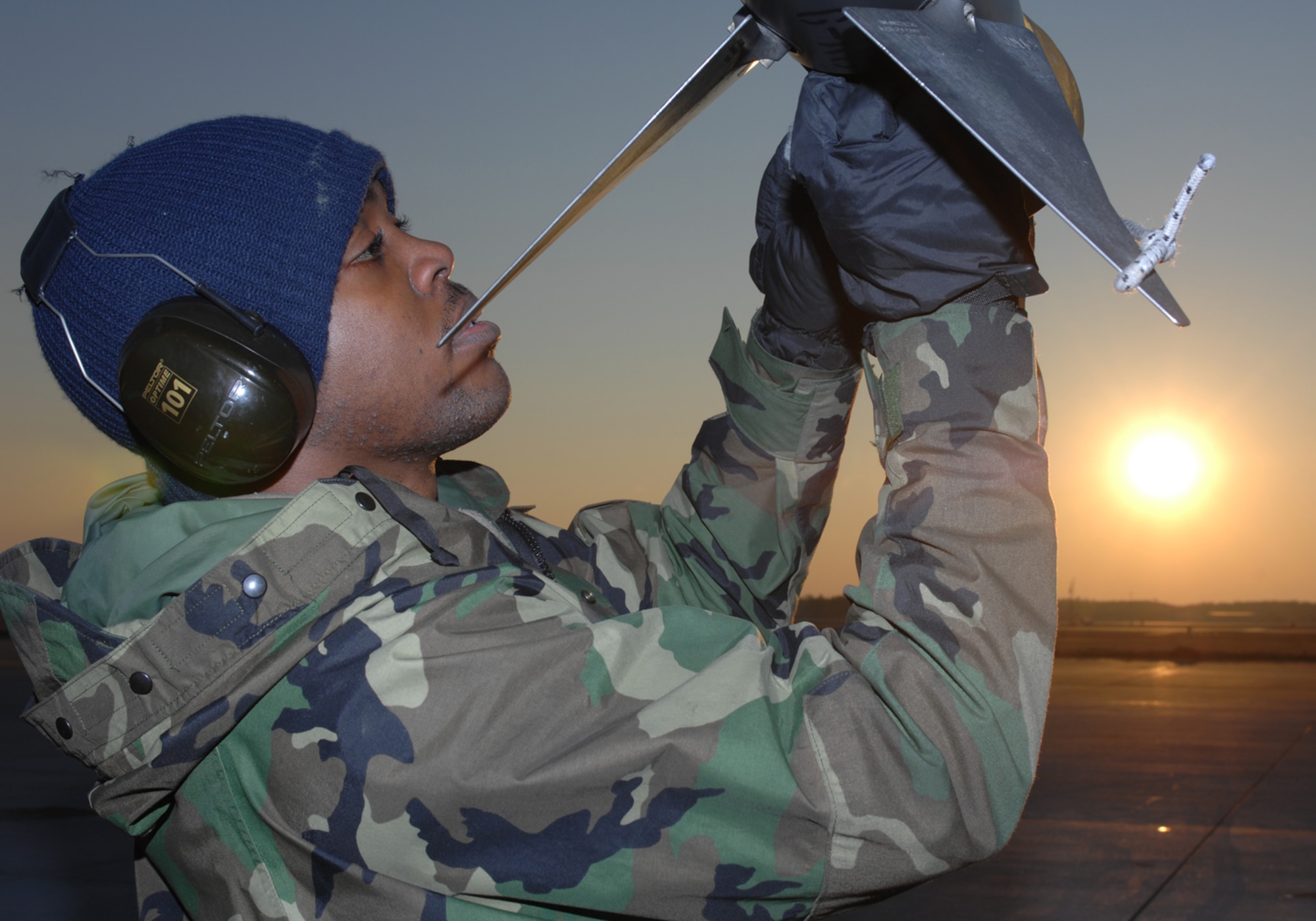 Airman 1st Class Wilbert Dixon replaces the cooling componet on an AIM-9 missle in support of Exercise Iron Thunder  Feb. 7 at Shaw Air Force Base, S.C. The objective of the exercise is to prepare units for future contingency operations by offering a chance for players to be exposed to missions identical to those faced in combat. Airman Dixon is a 77th Fighter Squadron weapons specialist. (U.S. Air Force photo/Airman 1st Class Matthew Davis)