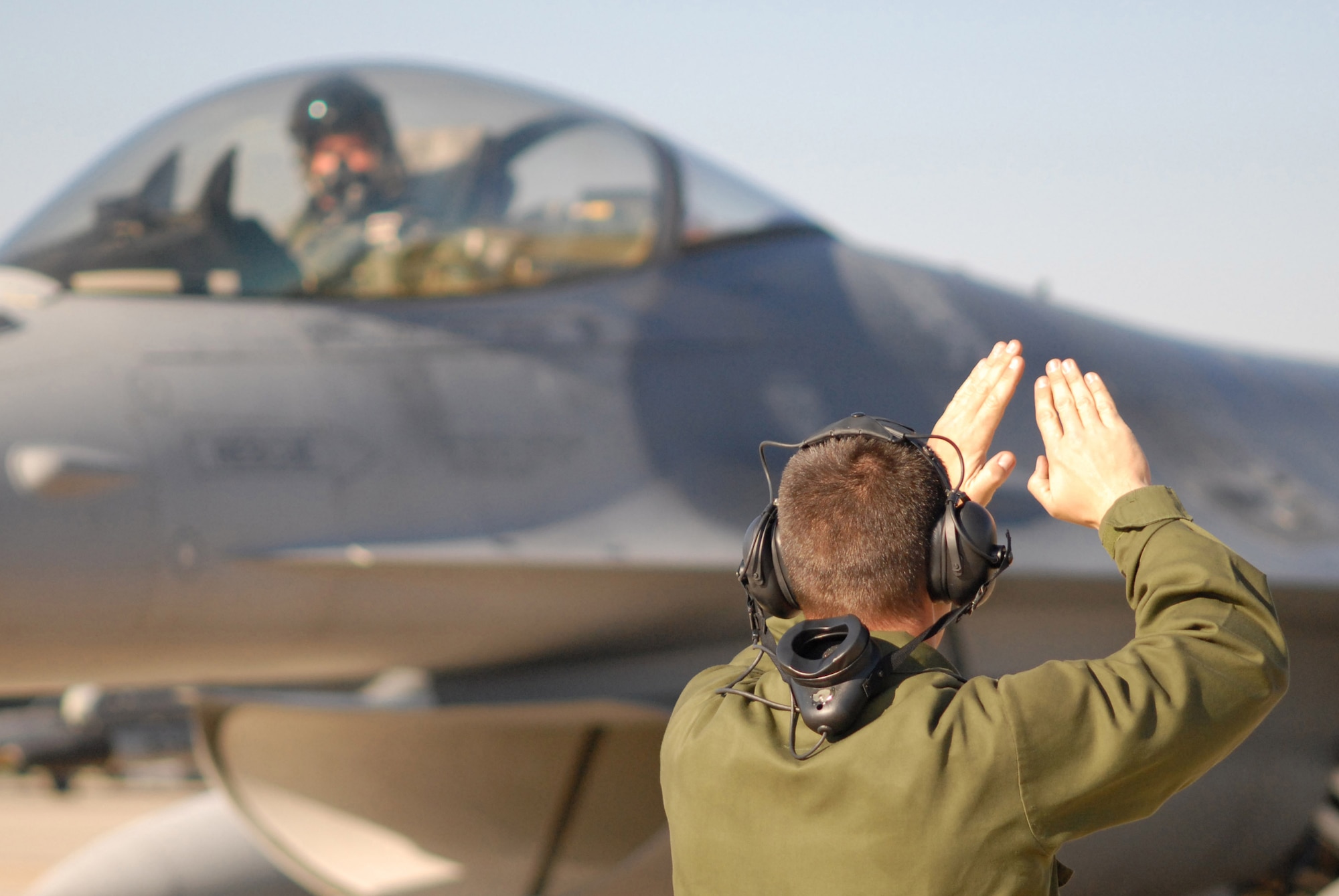 Staff Sgt. Donald Slayton marshals an F-16 Fighting Falcon in support of Exercise Iron Thunder Feb. 7 at Shaw Air Force Base, S.C. The objective of the exercise is to prepare units for future contingency operations by offering a chance for players to be exposed to missions identical to those faced in combat. Sergeant Slayton is a 77th Fighter Squadron crew chief. (U.S. Air Force photo/Tech. Sgt. James W. Arrowood)