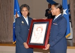 Retired Brig. Gen. Toreaser Steele is presented a framed portrait of herself that was drawn in sepia pencil from her photograph by Rick Campos, 37th Contracting Squadron. General Steele, who was commander of Lackland's 737th Training Group for two years from 1996-98, retired as commander of the Army and Air Force Exchange Service. General Steele, speaker for the African-American Heritage Month kickoff luncheon Feb. 6 at the Gateway Club on Lackland Air Force Base, Texas, is receiving the gift from 2nd Lt. Andrea Jackson, 37th CONS. The drawing was commissioned by Lackland's African-American Heritage Committee. (USAF photo by Robbin Cresswell)