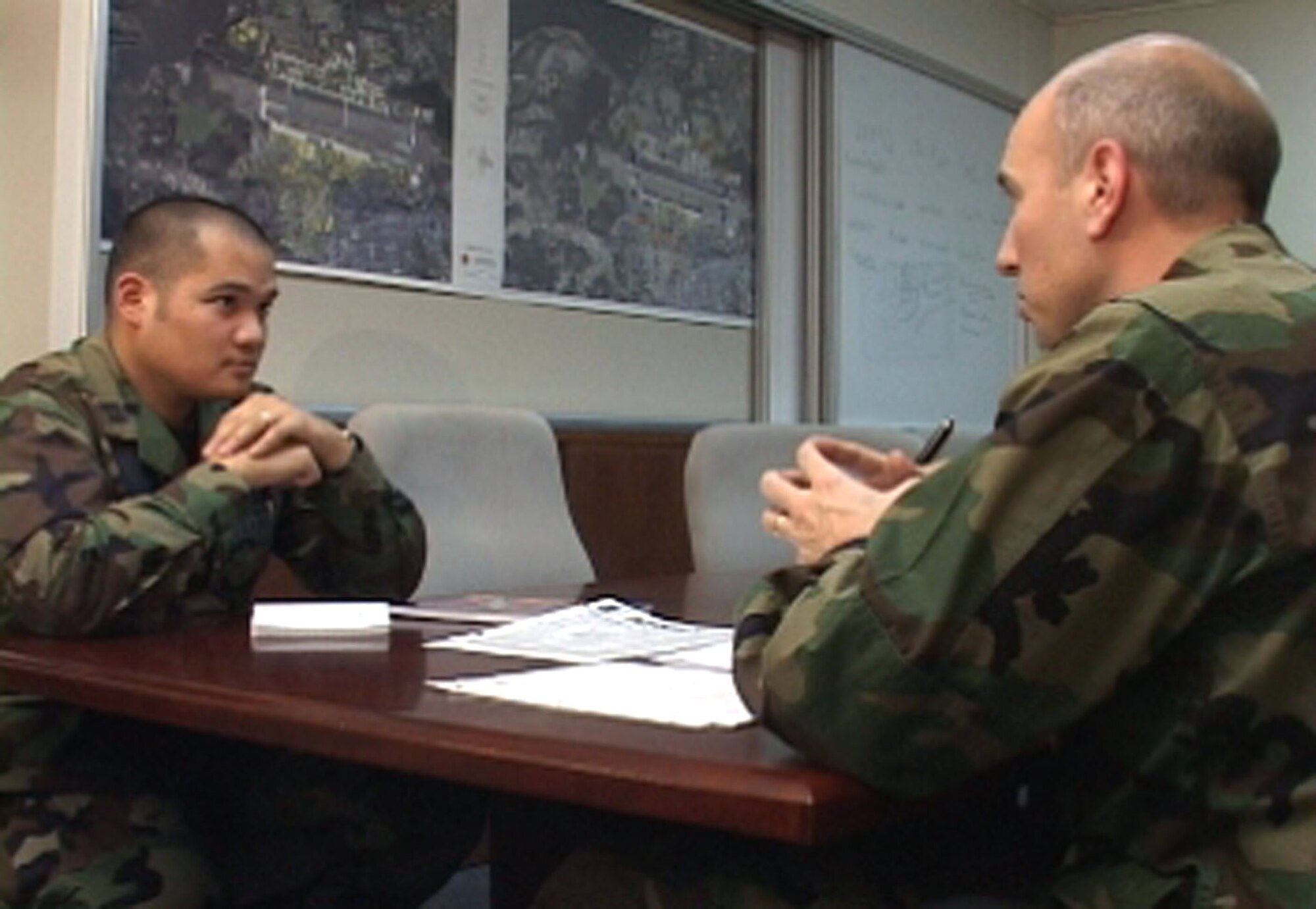 Lt. Col. Joseph Marcinkevich (right) mentors Capt. Harold Tongson during a feedback session. Air Force members are required to have at least an initial, mid-term, and follow-up session with their supervisors to identify strengths and areas needing improvement. (U.S. Air Force photo)
