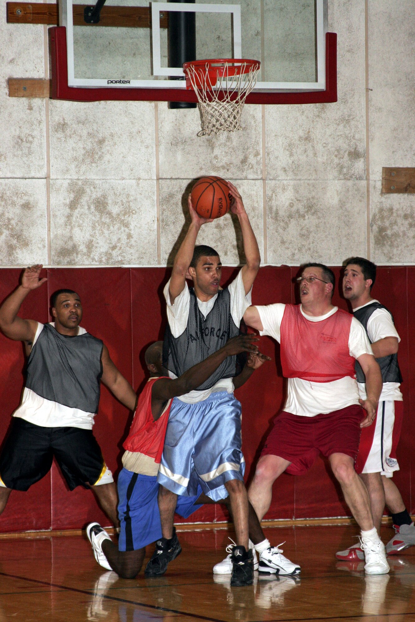 GRISSOM AIR RESERVE BASE, Ind.--Brandon Williams, 434th Logistics Readiness Squadron, looks to kick the ball out after nabbing a rebound against the 434th Security Forces Squadron. LRS defeated the cops 49-48 to advance to the third round of the annual basketball tournament on last second shot by Williams. (U.S. Air Force photo/Senior Airman Omar Delacruz)