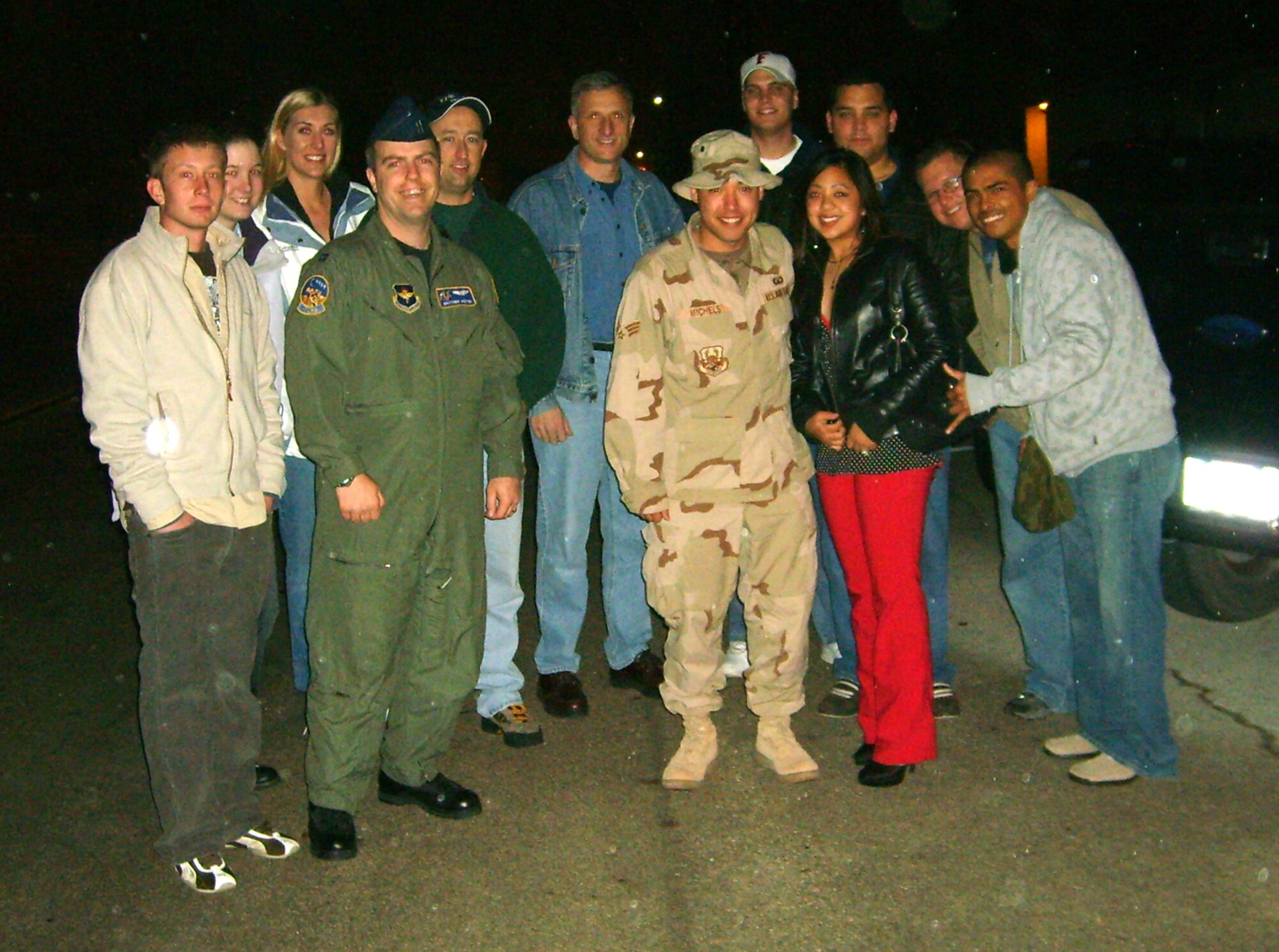 LAUGHLIN AIR FORCE BASE, Texas -- Friends and coworkers came out in the drizzling rain around 2 a.m. Feb. 11 to welcome Senior Airman Anthony Michels, 47th Operations Support Squadron Radar Approach Control, home from an almost five-month deployment in support of Operation Iraqi Freedom.  (U.S. Air Force photo by Staff Sgt. Austin M. May)