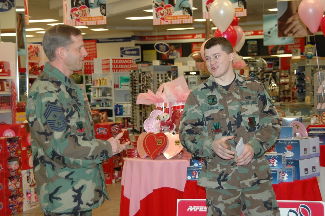 Chief Master Sgt. John Gillette, 28th Bomb Wing command chief congratulates Airman 1st Class Kyle Strang, 28th Maintenance Squadron aerospace propulsion journeyman, for winning a $5,000 Army and Air Force Exchange Service shopping spree.
Airman Strang entered the After Thanksgiving Shopping Spree Sweepstakes at the Ellsworth Base Exchange. All AAFES locations drew only one name and forwarded it to AAFES headquarters in Dallas for the final drawing. Airman Strang is one of only 10 winners worldwide. 
Col. Jeffry Smith, 28th BW commander, Lt. Col. Todd McCready, 28th MXS commander, and staff and shoppers of the base exchange were also present for the presentation. (U.S. Air Force photo/Airman 1st Class Kimberly Moore Limrick)
