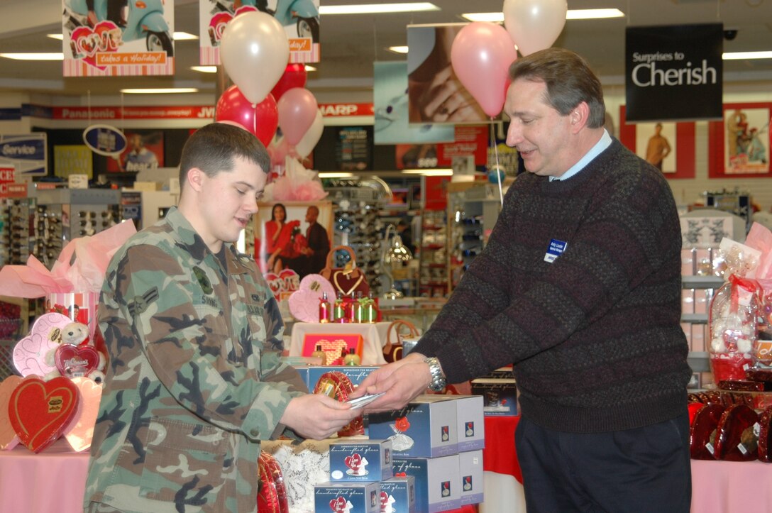 Airman 1st Class Kyle Strang, 28th Maintenance Squadron aerospace propulsion journeyman, receives a $5,000 Army and Air Force Exchange Service shopping spree from manager, Andy Louder.
Airman Strang entered the After Thanksgiving Shopping Spree Sweepstakes at the Ellsworth Base Exchange. All AAFES locations drew only one name and forwarded it to AAFES headquarters in Dallas for the final drawing. Airman Strang is one of only 10 winners worldwide. (U.S. Air Force photo/Airman 1st Class Kimberly Moore Limrick)
