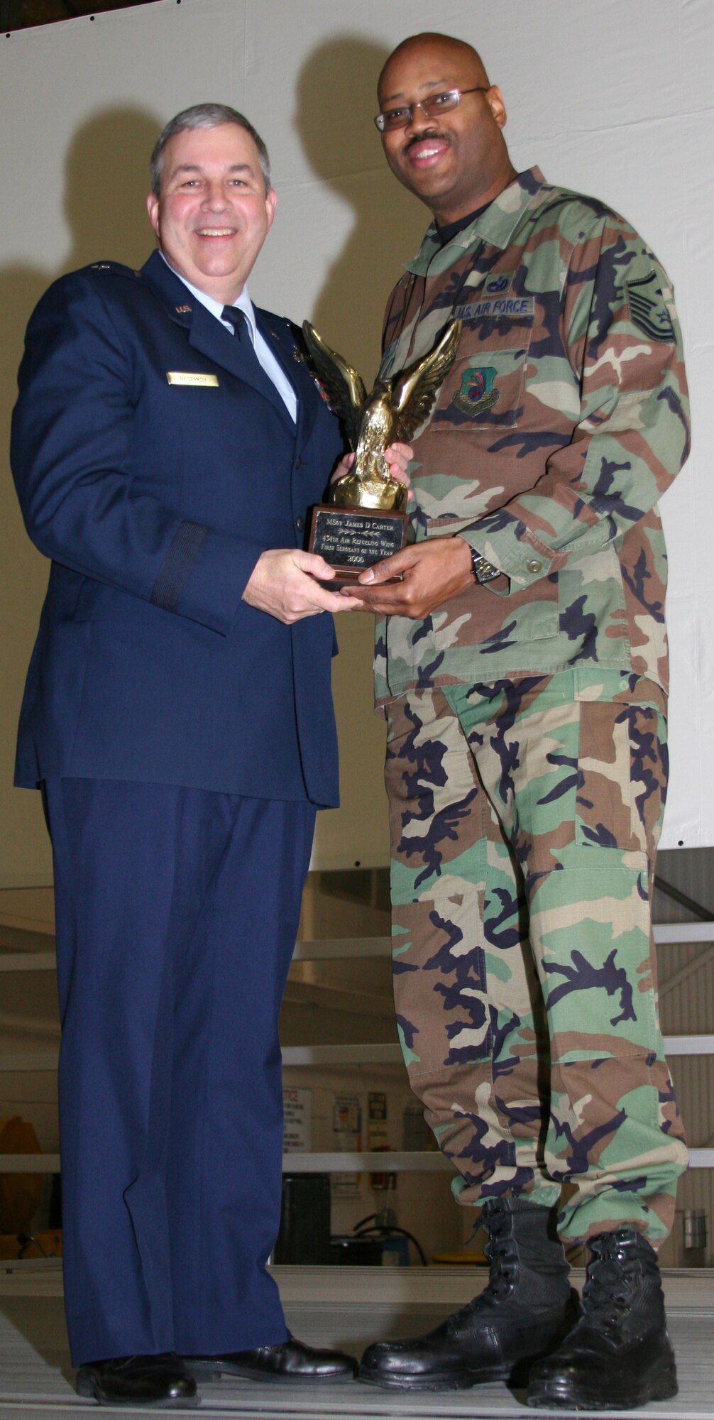 GRISSOM AIR RESERVE BASE, Ind., -- Brig. Gen. Dean Despinoy, left, 434th Air Refueling Wing Commander, presents Master Sgt. James Carter, 434th Logistics Readiness Squadron, a plaque in recognition of his selection as the First Sergeant of the Year for  2006. (U.S. Air Force photo/Senior Airman Omar Delacruz)