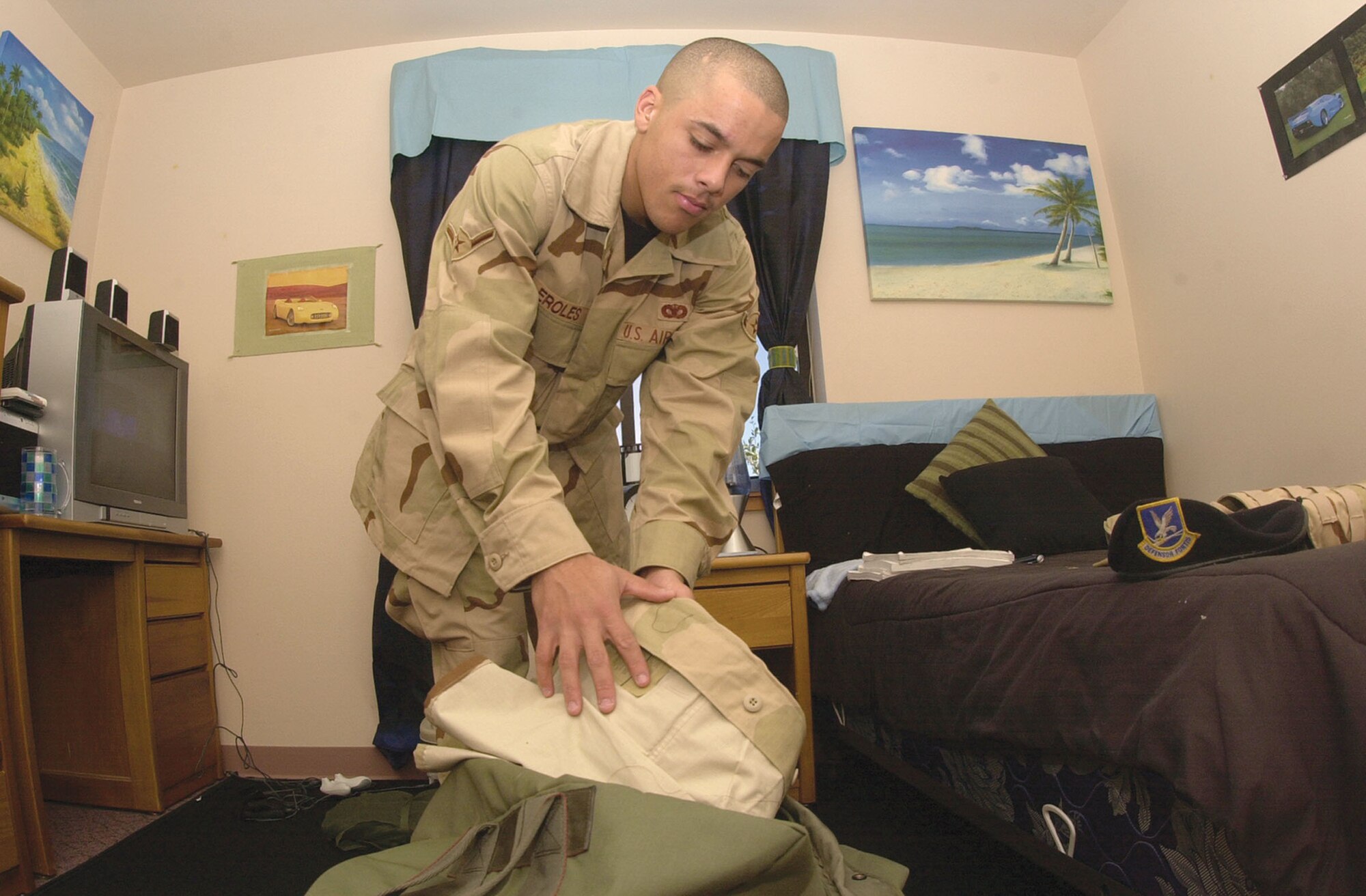 Airman Michael Eroles, a member of the 17th Security Forces Squadron, packs his duffle bag Wednesday inside his bedroom here. Airman Eroles is one of several servicemembers from Goodfellow scheduled to deploy this month.  	

“I’m very excited about getting deployed,  I look forward at the opportunity to learn about other cultures,” Airman Eroles said. “I think this deployment will be a great learning experience.  I know I will miss many things and many people while I’m gone, but I know I’m simply fulfilling part of my commitment to serve my country,” he added. (U.S Air Force photo by Airman 1st Class Luis Loza Gutierrez.)

