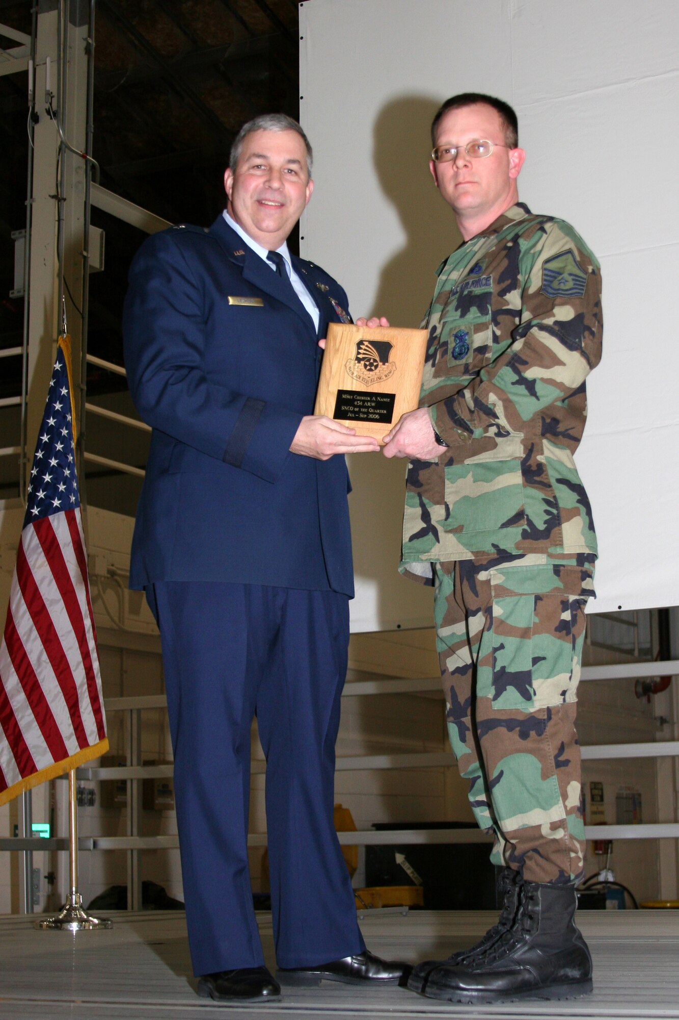 GRISSOM AIR RESERVE BASE, Ind., -- Brig. Gen. Dean Despinoy, left, 434th Air Refueling Wing Commander, presents Master Sgt. Chet Nance, 434th Security Forces Squadron, a plaque in recognition of his selection as the Wing's Senior NCO of the Quarter for the fourth quarter of 2006. (U.S. Air Force photo/Senior Airman Omar Delacruz)