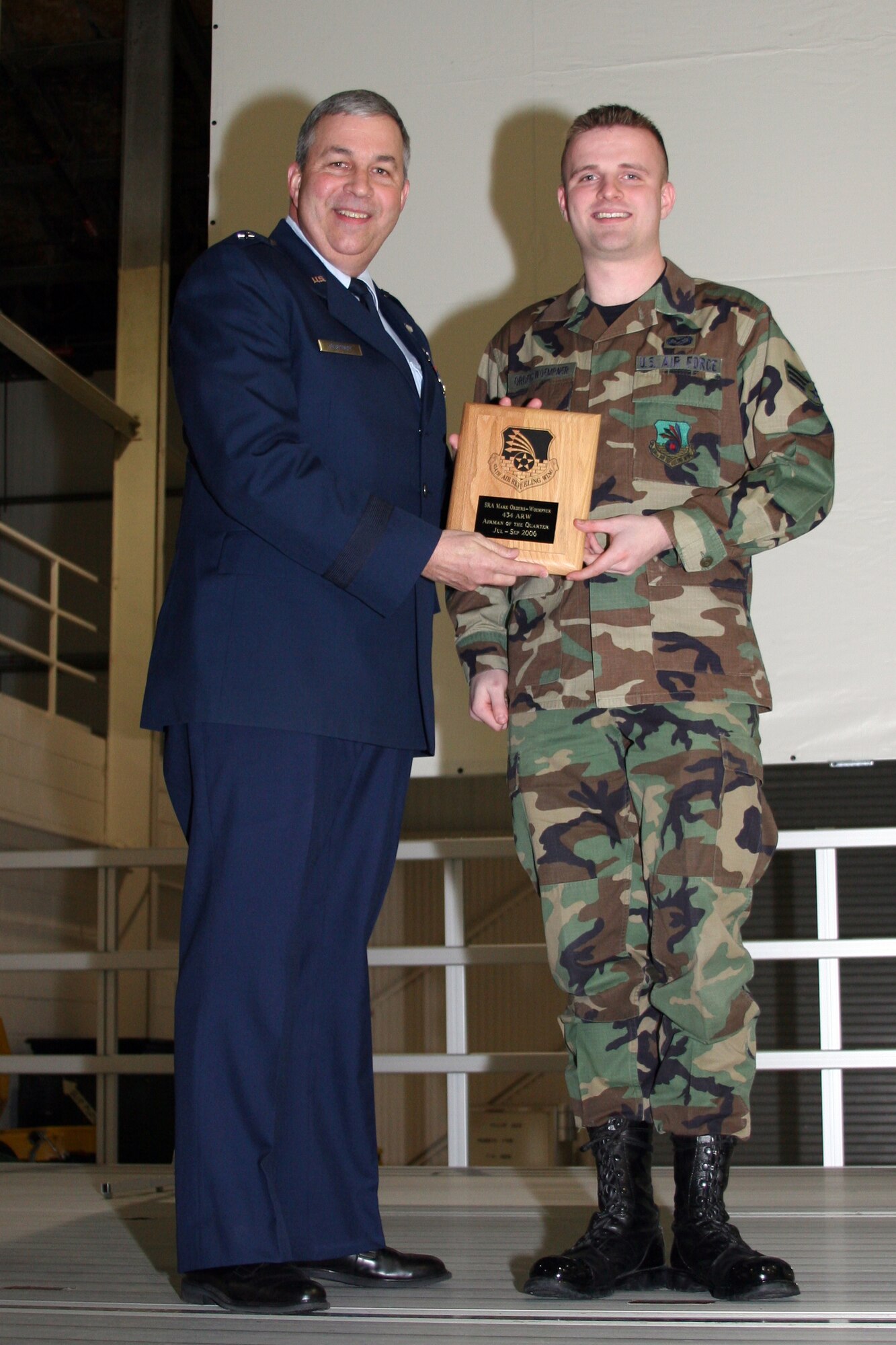 GRISSOM AIR RESERVE BASE, Ind., -- Brig. Gen. Dean Despinoy, left, 434th Air Refueling Wing Commander, presents Senior Airman Mark Orders-Woempner a plaque in recognition of his selection as the Wing's Airman of the Quarter for the fourth quarter of 2006. (U.S. Air Force photo/Senior Airman Omar Delacruz)