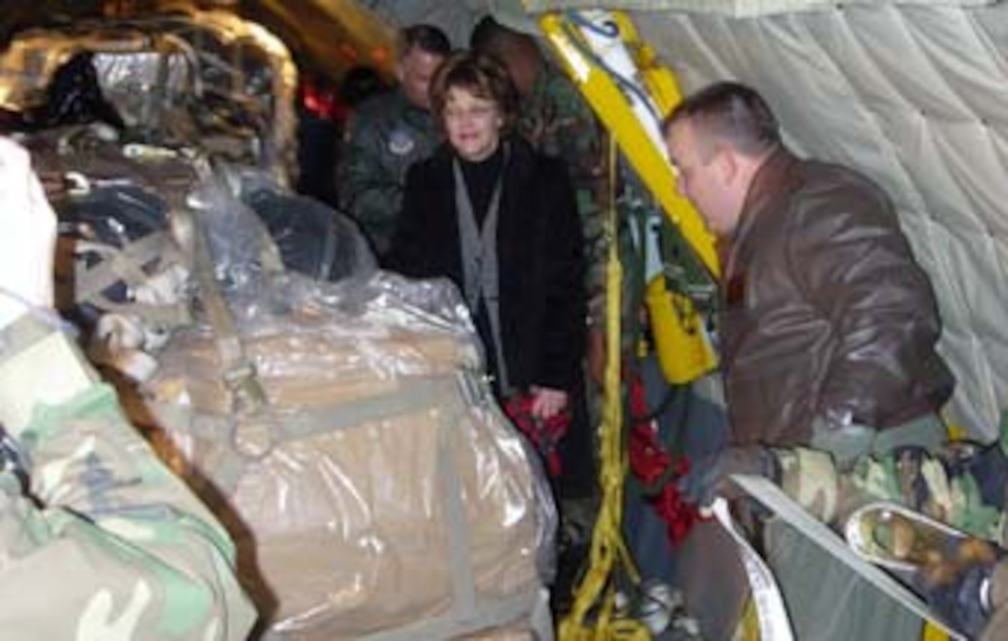 Mrs. Jan Bradley, wife of Air Force Reserve Command commander, Lt. Gen. John A. Bradley, walks through a 459th Air Refueling Wing KC-135 Stratotanker at Andrews Air Force Base, Md, Feb. 10. Mrs. Bradley, through her volunteer organization, Sew Much Comfort, donated pillows, blankets, gloves and many other items to the Air Force Chaplain's Wounded Warrior program. Those items aboard the aircraft were flown to Landstuhl Regional Medical Center, Germany to provide clothing for wounded troops there.  