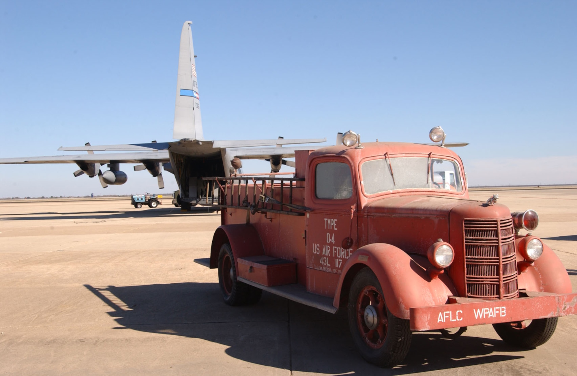 A 1942 Mack Model 125 fire truck on the flightline at Mathis Field San Angelo Regional Airport. The fire truck, to be used as a static display at the outdoor museum on Goodfellow, was transported by a C-130 Hercules from the 910th Airlift Wing, Youngstown, Ohio.  (U.S. Air Force photo by Staff Sgt. Angela Malek.)