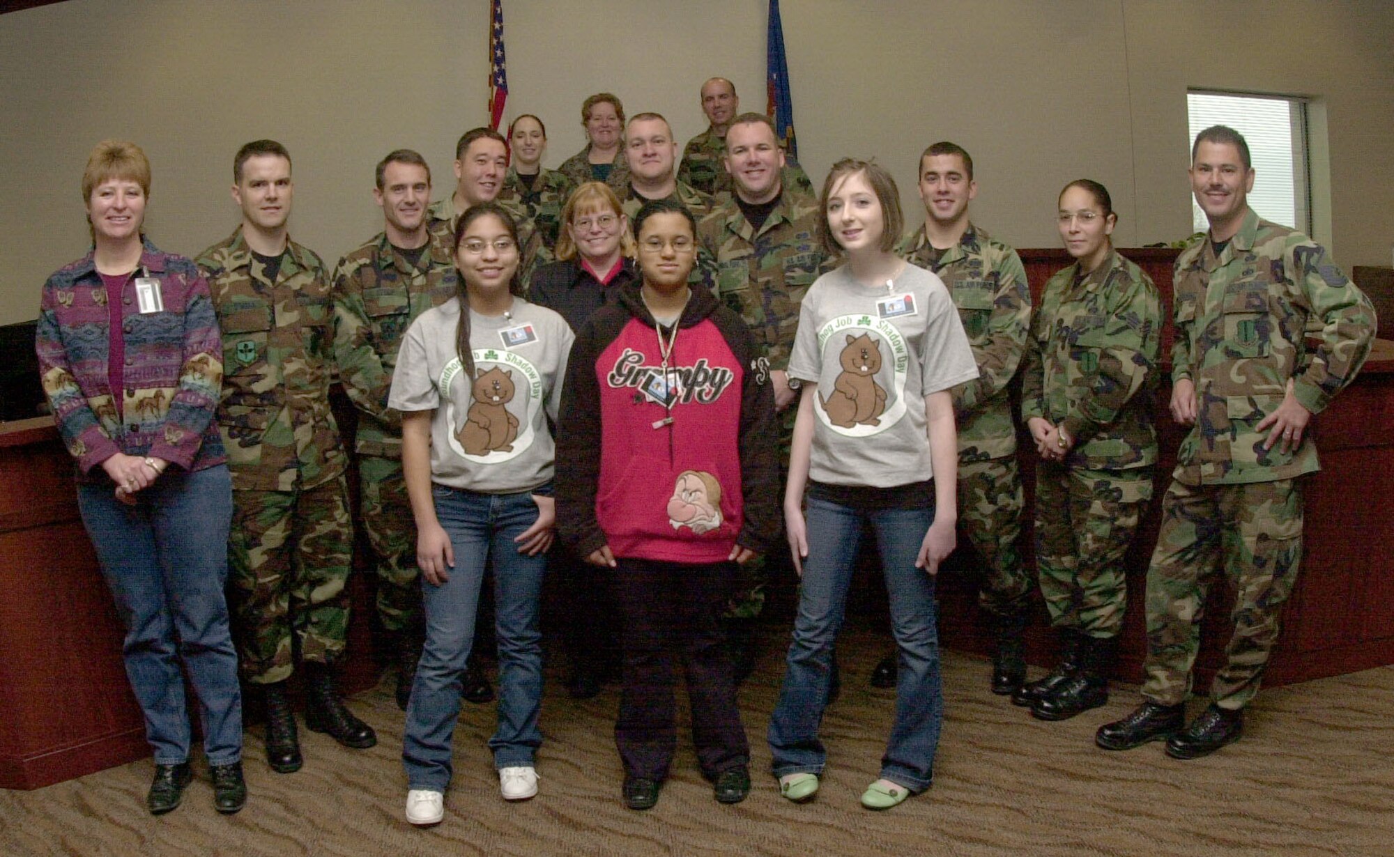 Members of the 17th Training Wing legal office pose for a group photo with three students participating in Groundhog Job Shadow Day. The legal office had the students act as jurors during a mock trial, also known as a court martial. (U.S. Air Force photo by Airman 1st Class Luis Loza Gutierrez)