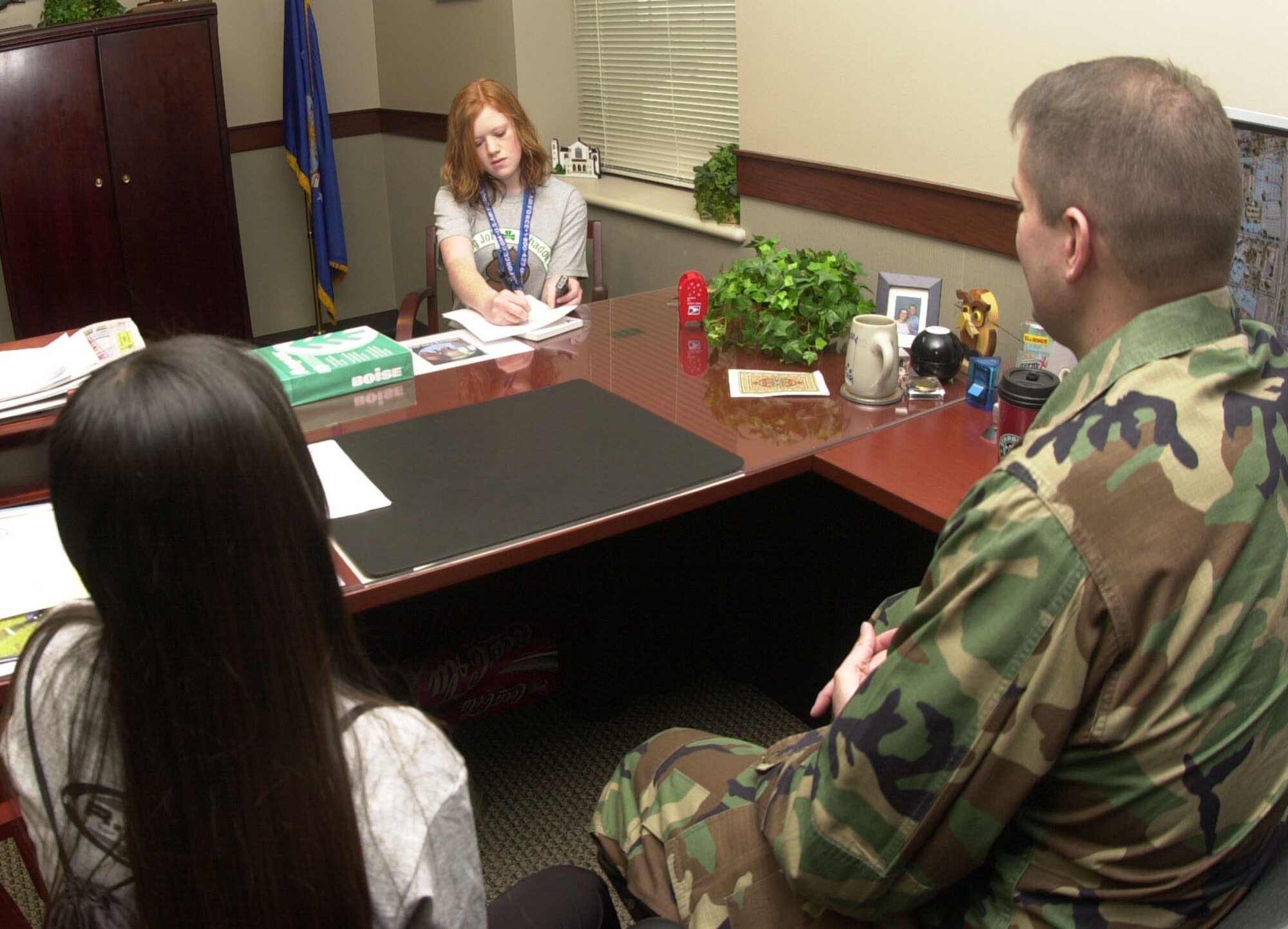 Grace Foulk, Goodfellow Monitor guest reporter (at center), interviews Maj. Stephen Cristofori, 17th Comptroller Squadron commander, about being a volunteer mentor during this year’s Groundhog Job Shadow Day, while Mayra Del Riva, a freshman from Lakeview High School and participant in the program, listens in. (U.S. Air Force photo by Airman 1st Class Luis Loza Gutierrez)