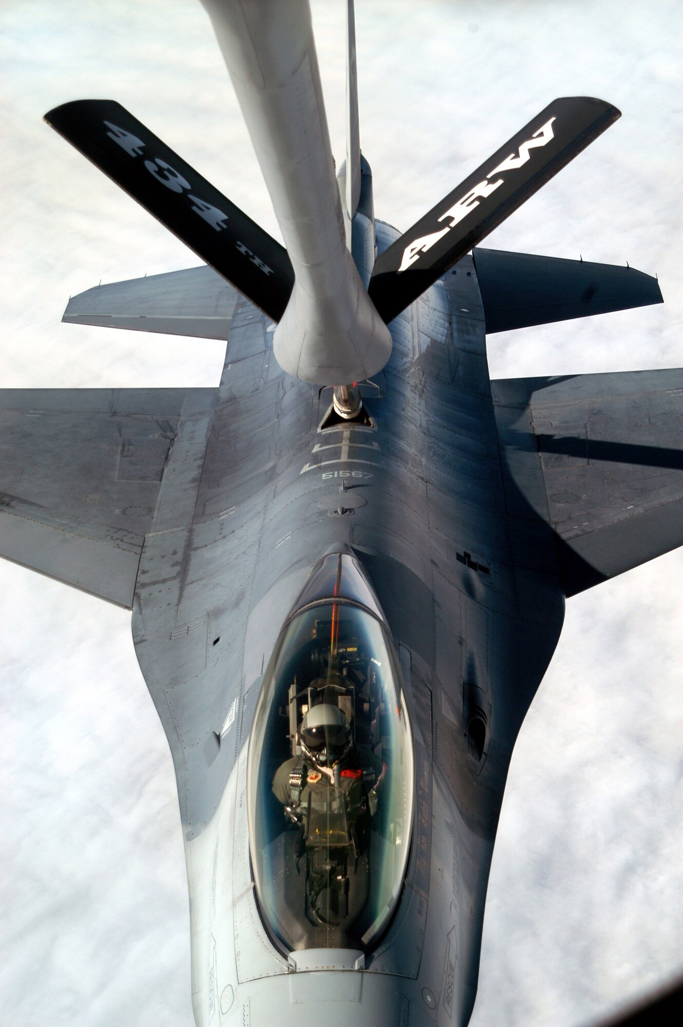 GRISSOM AIR RESERVE BASE, Ind., -- The pilot of an F-16 from the 181st Fighter Wing, Terre Haute, Ind., looks up as he receives fuel from a KC-135R Stratotanker from the 434th Air Refueling Wing here. The 434th ARW routinely deploys around the world in support of the Air Force mission, and trains to be an unrivaled wingman. (U.S. Air Force photo/Senior Airman Mark Orders-Woempner)