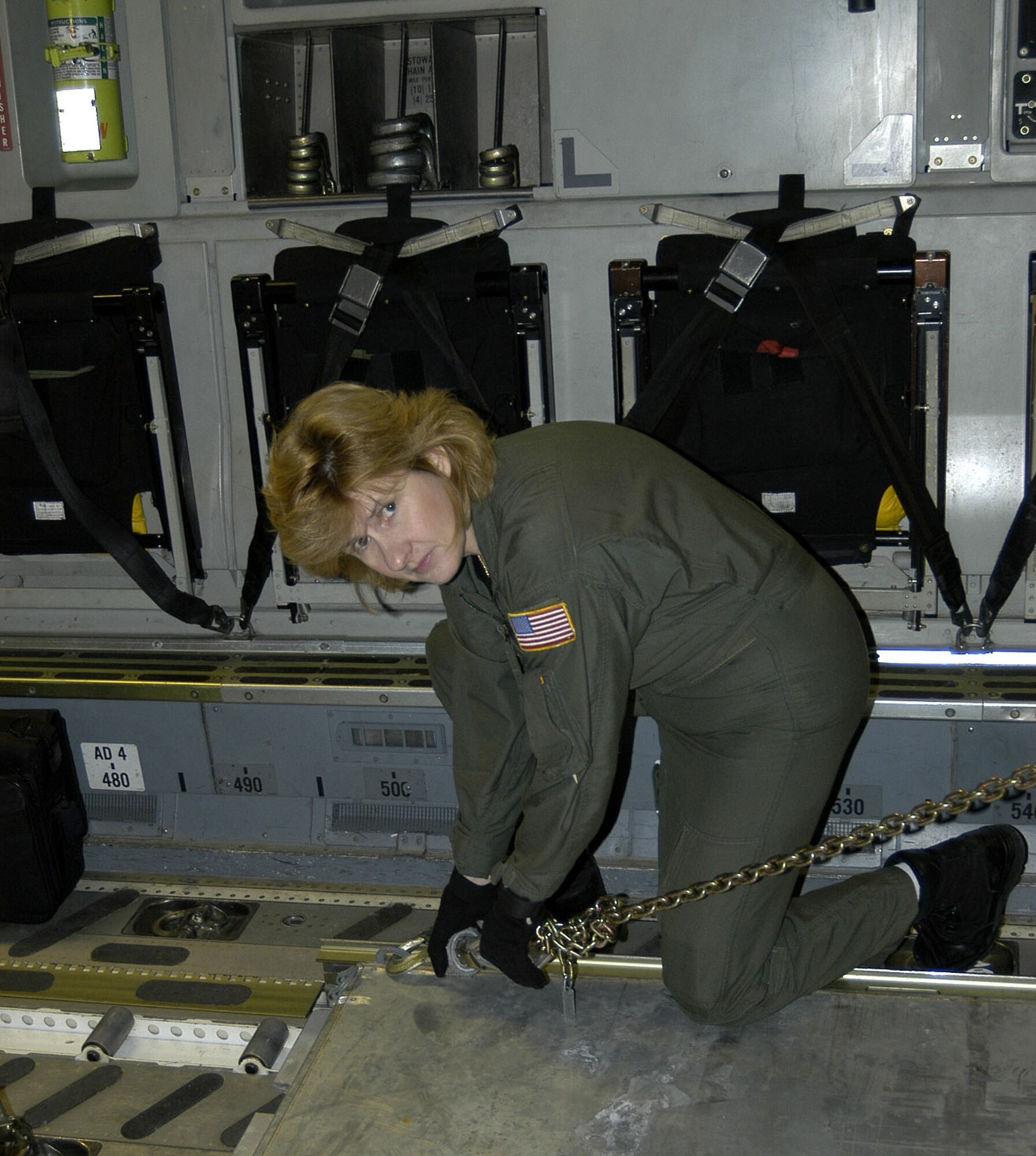 Senior Master Sgt. Kathy Lambert, 326 AS, Dover AFB, Del., ensures the cargo is secured before take-off.  She recently flew a Pacific Express mission with a crew from the 317 AS, Charleston AFB, S.C.                                