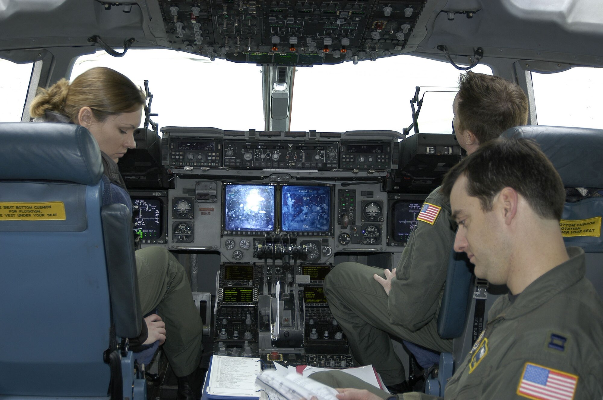 Capt Scott Huebel, Aircraft commander, Maj. Jason Williams and 1st Lt. Amanda Gierhart, all assigned to the 315th Airlift Squadron, Charleston AFB, SC., check over data for the Pacific Express Mission.  The Pac Express Mission provides a carrier for opportune cargo and passengers through out the Pacific theatre.                            