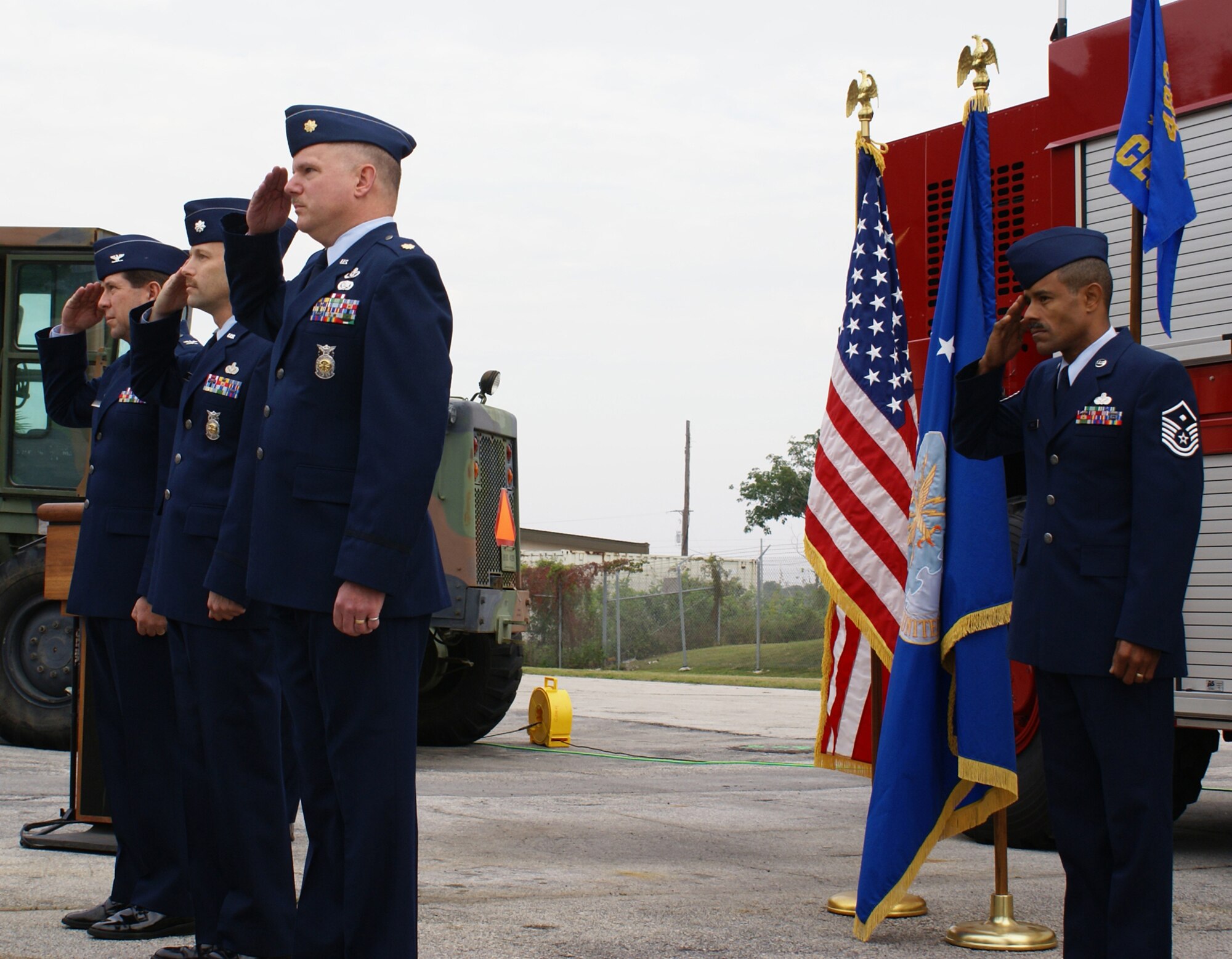 Maj. William S. Riehl III, Lt. Col. Mark Wolfe and 482 Mission Support Group Commander Col. Dennis Daley salute during a change of command ceremony here at Homestead Air Reserve Base Feb. 11.  During the ceremony, Lt. Col. Mark Wolfe relinquished command of the squadron to Maj. William S. Riehl, III.   Lt. Col. Wolfe is retiring after six years as the CES commander.   Also pictured is Master Sgt. Luis Mateo, 482nd CES First Sgt.  (U.S. Air Force photo/Jake Shaw)   