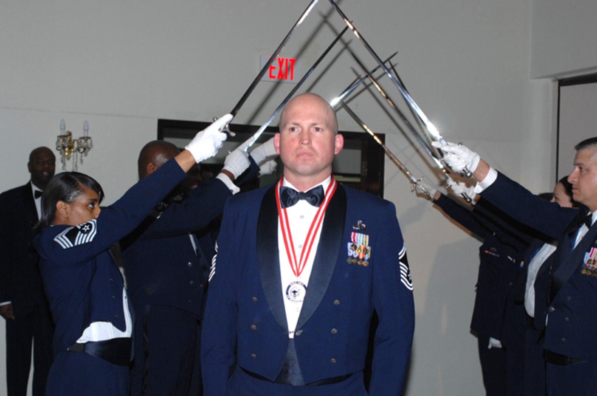 Senior Master Sgt. Steven Lantz from the 39th Operations Squadron passes through the Honor Guard cordon of swords during the Chief Induction Ceremony Feb. 9 at the Consolidatedd Club. (U. S. Air Force Photo by Technical Sergeant Shirley Henderson)